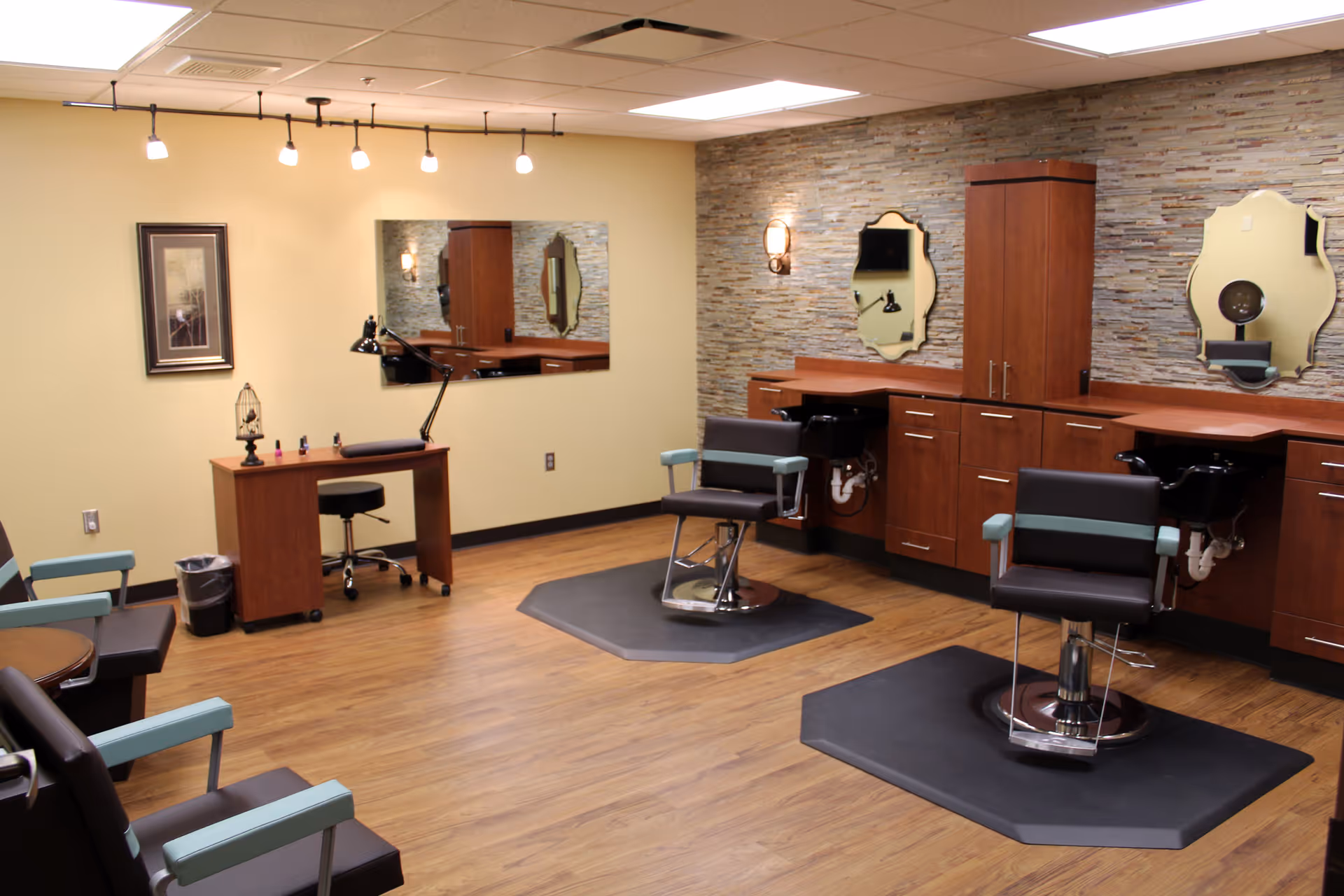 Sunlit senior living facility salon with mirrors, wooden stations, and barber chairs.