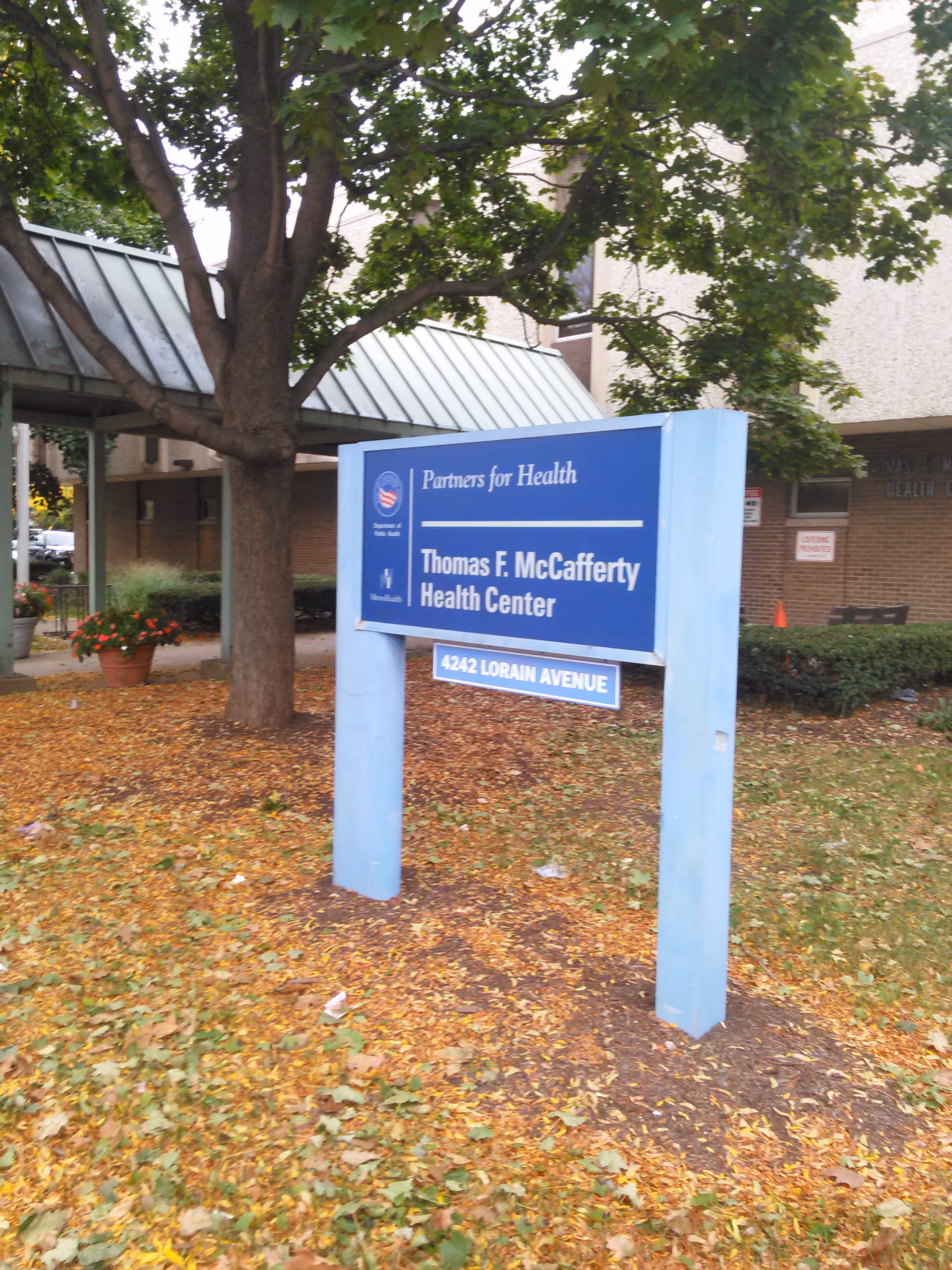 Blue sign for Thomas F. McCafferty Health Center in front of a building.
