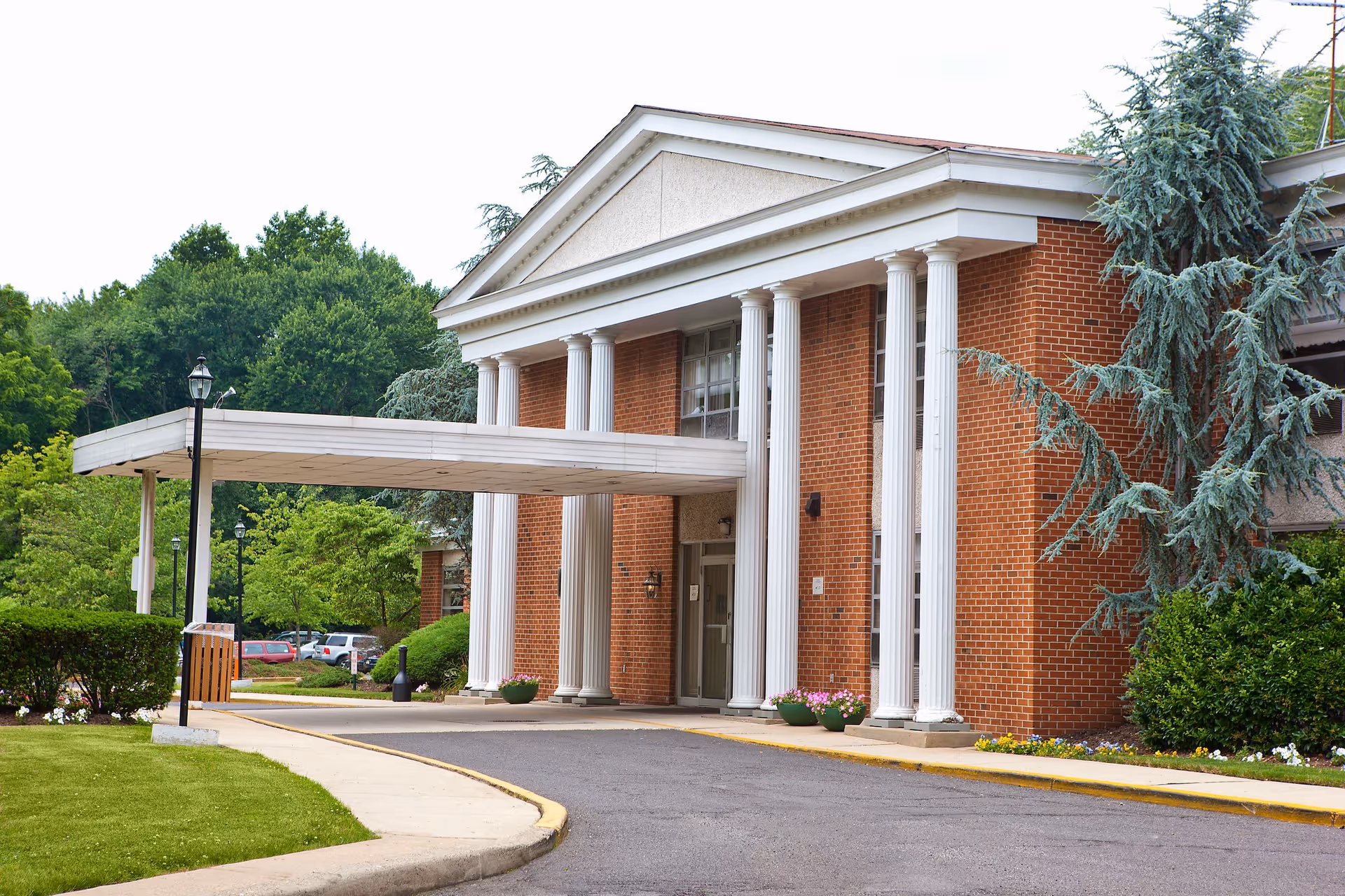 Exterior view of Abingdon Care & Rehabilitation Center with brick facade and columns.