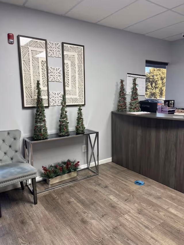 Lobby reception area in a senior living facility with a curved front desk and decor.