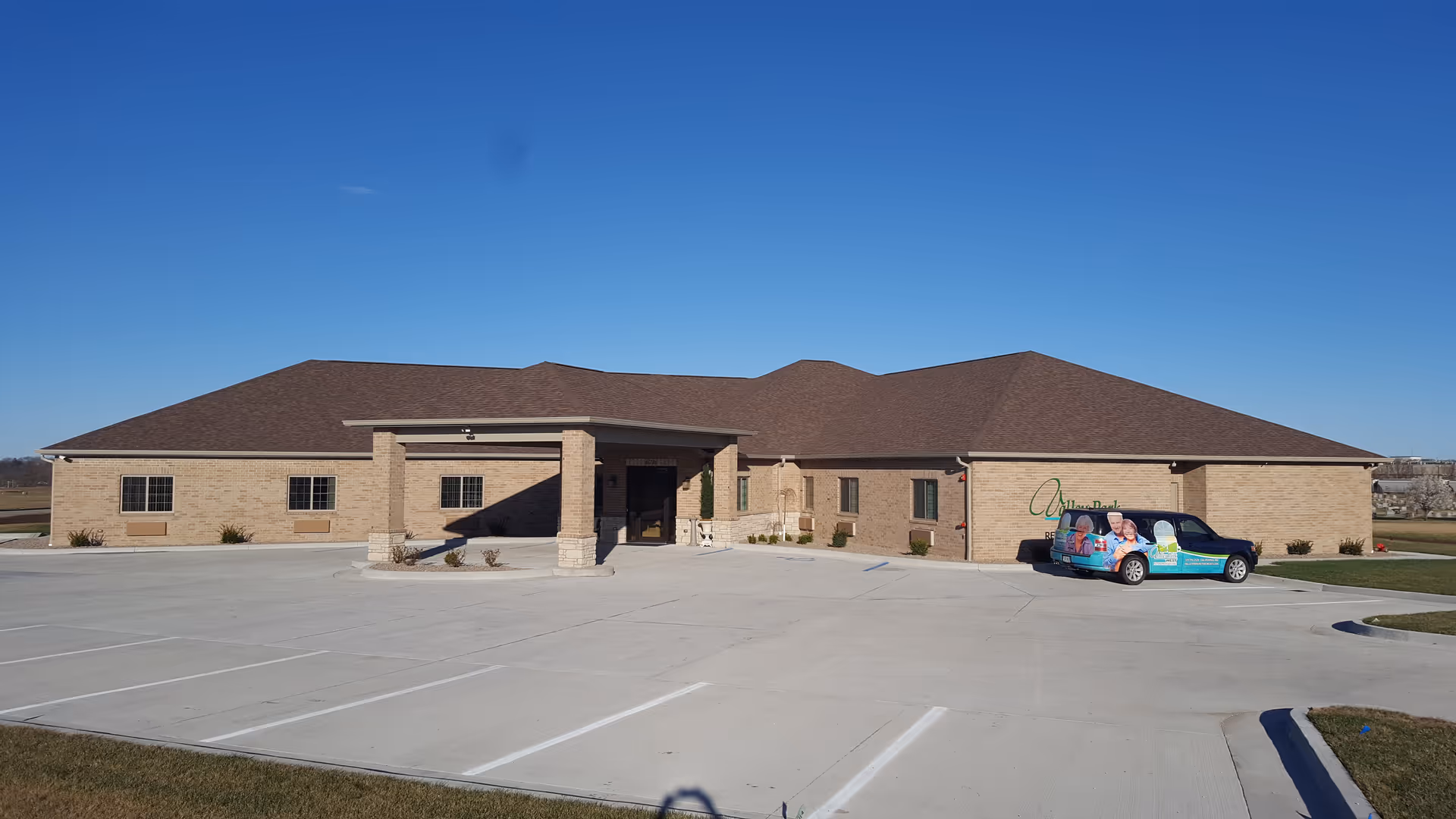 Front view of Valley Park Retirement Center, a single-story brick building with a covered entrance.