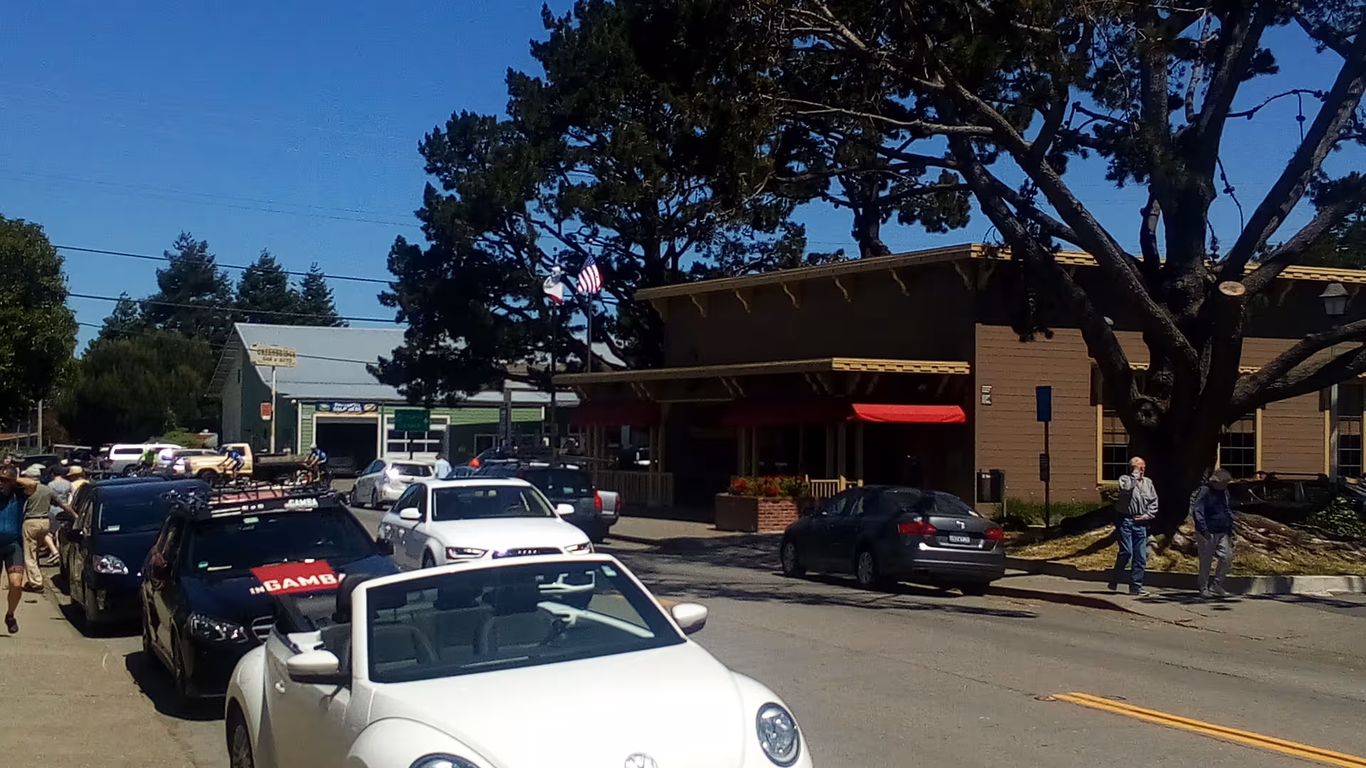 Exterior view of Windsong of Sonoma Senior Living with parked cars and pedestrians.