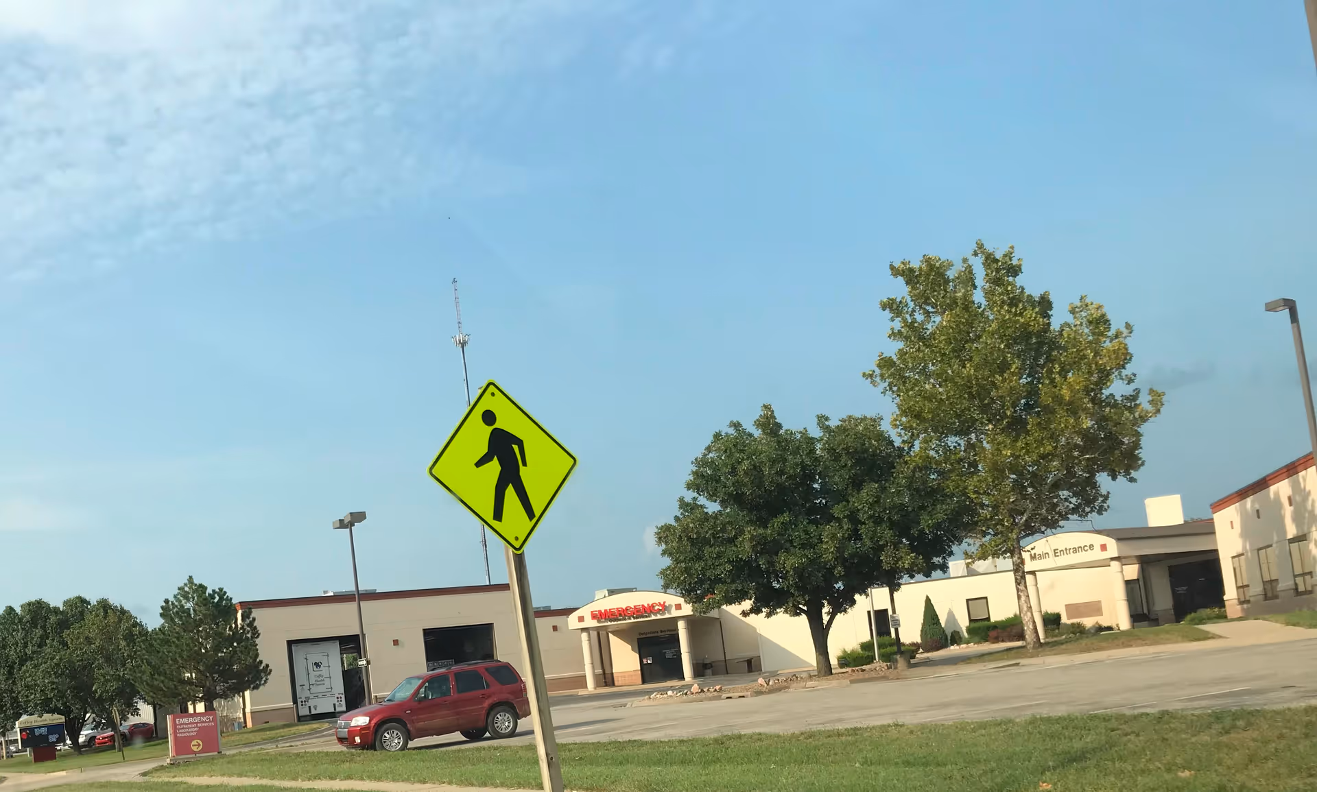 Exterior view of Coffey County Hospital with main entrance and vehicles nearby.