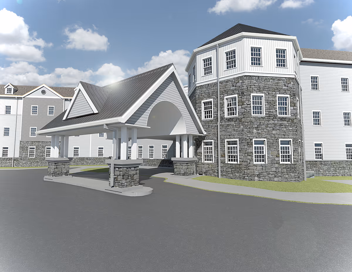 Exterior view of a senior living facility with stone facade and covered entrance.