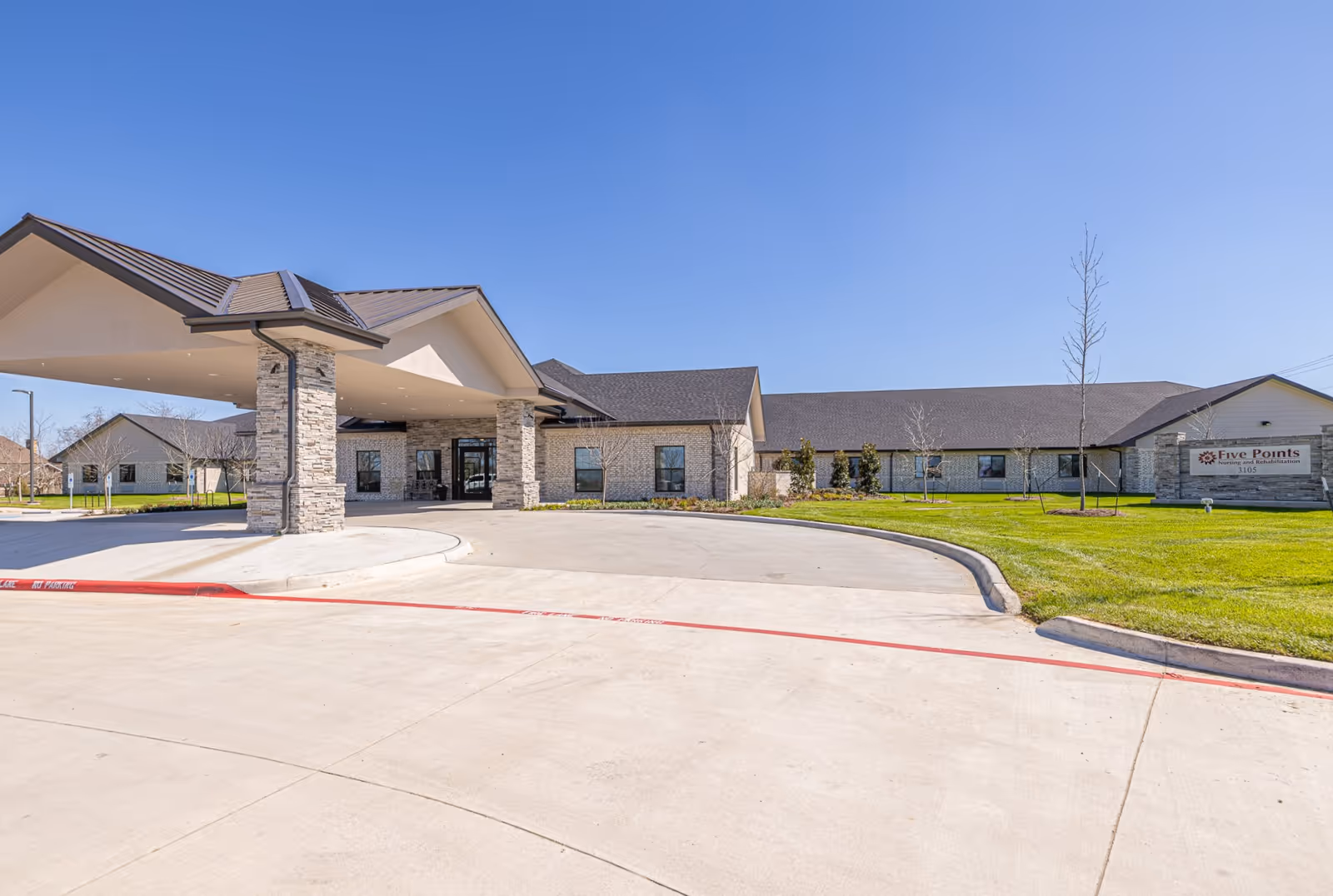 Exterior view of Five Points of College Station with entrance canopy and circular drive.