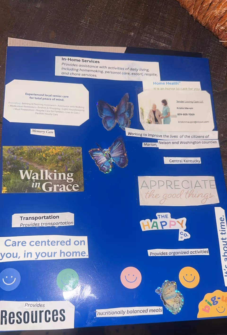 Blue information board with cut-out service labels and butterflies.