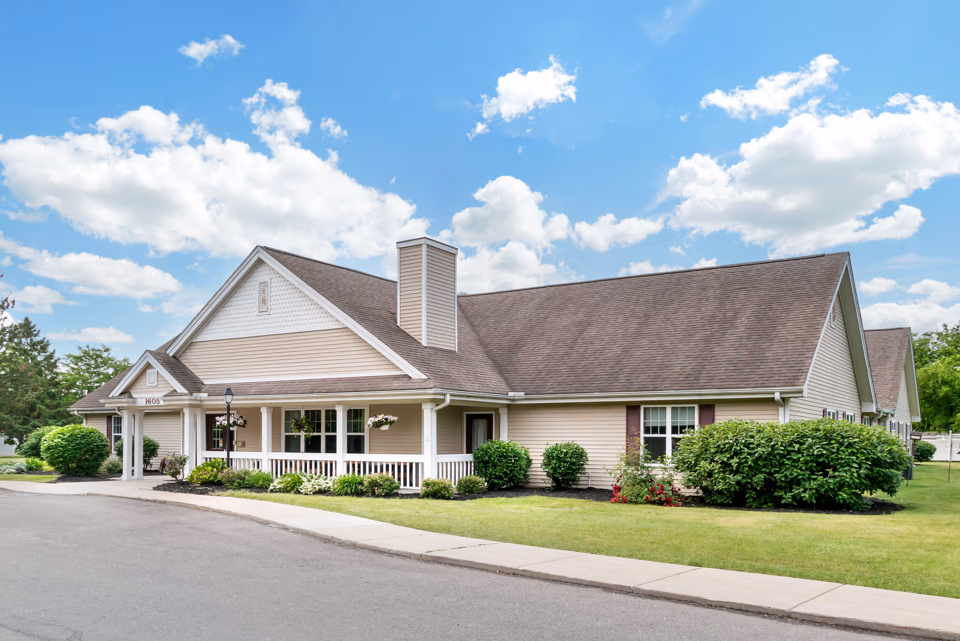 Front view of Brookdale Monroe senior living facility with a covered entrance and landscaping
