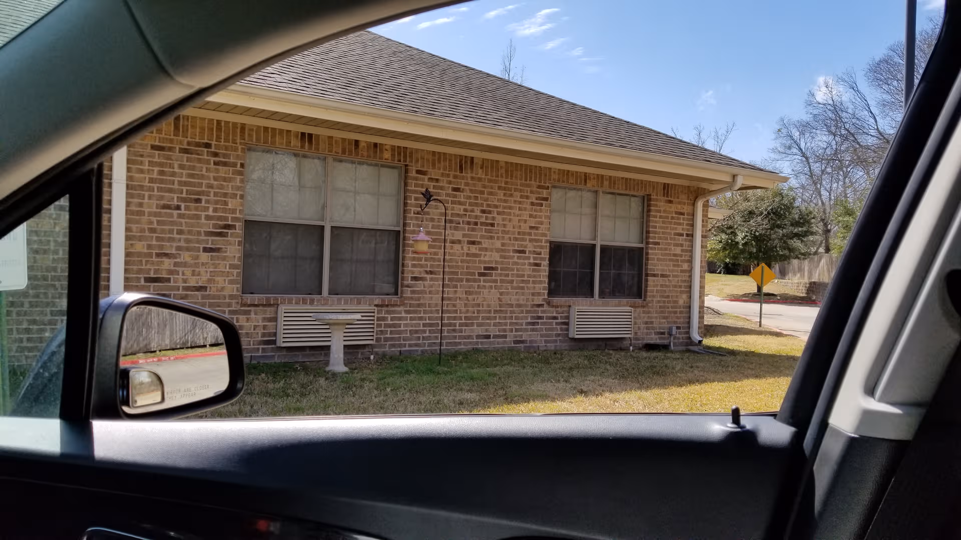 Exterior view shows Riverside Nursing and Rehabilitation Center's brick front with two large windows.