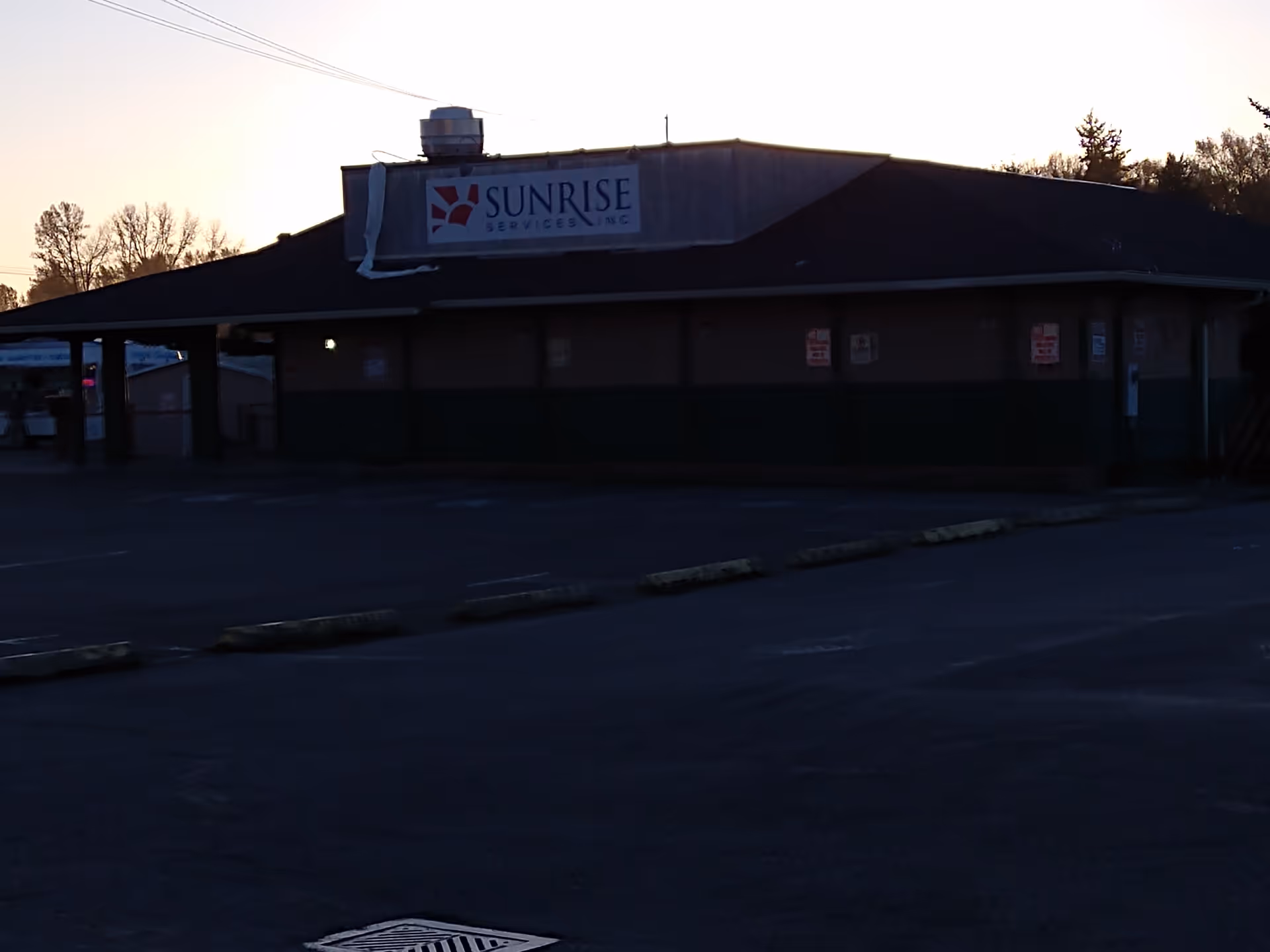 Sunrise Home Care Agency building exterior at dusk with a front sign.