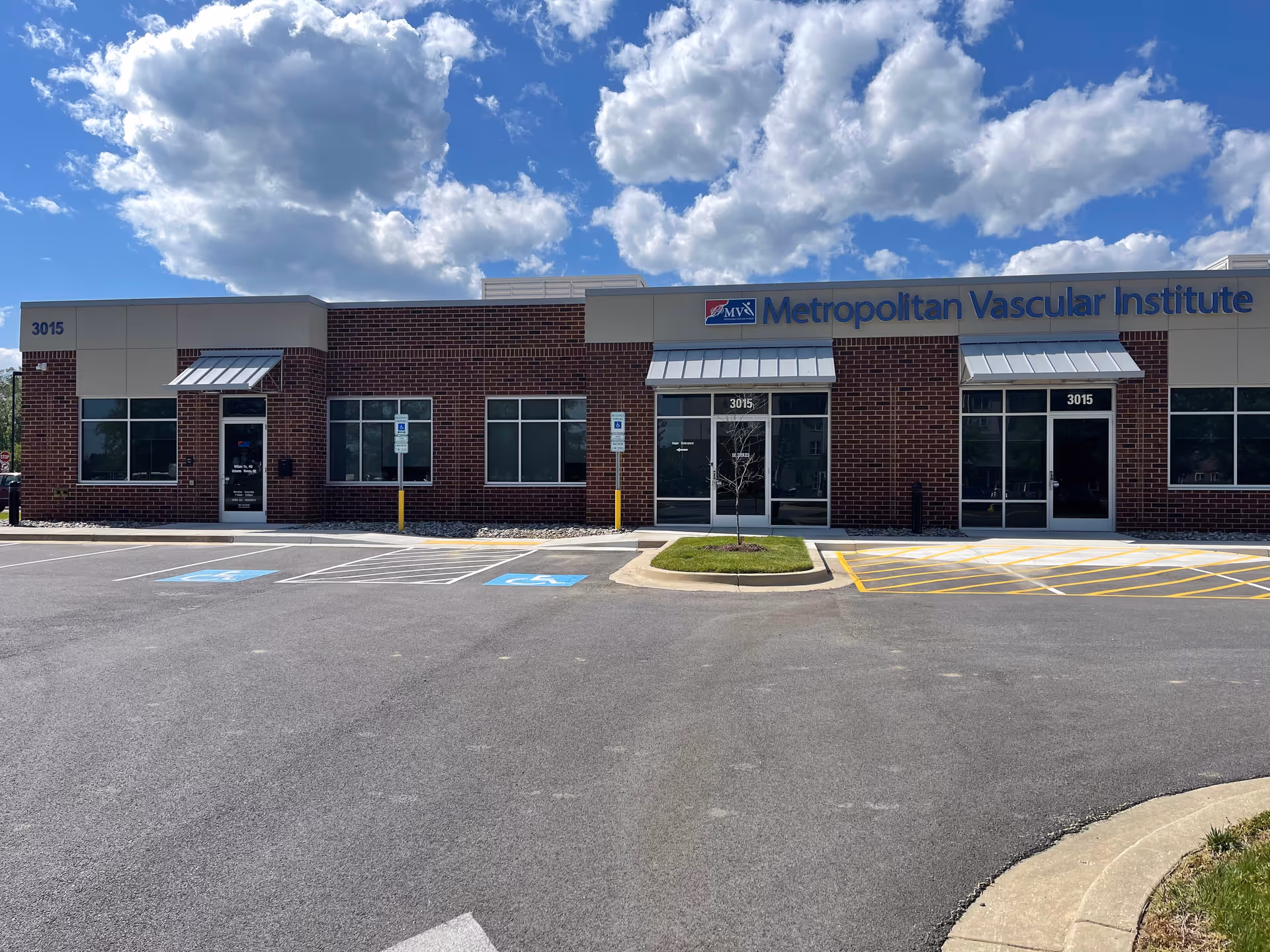 Exterior view of a brick building labeled Metropolitan Vascular Institute with front parking.