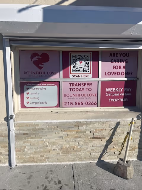Front of a building with pink Bountiful Love Home Health Care signs and a QR code.