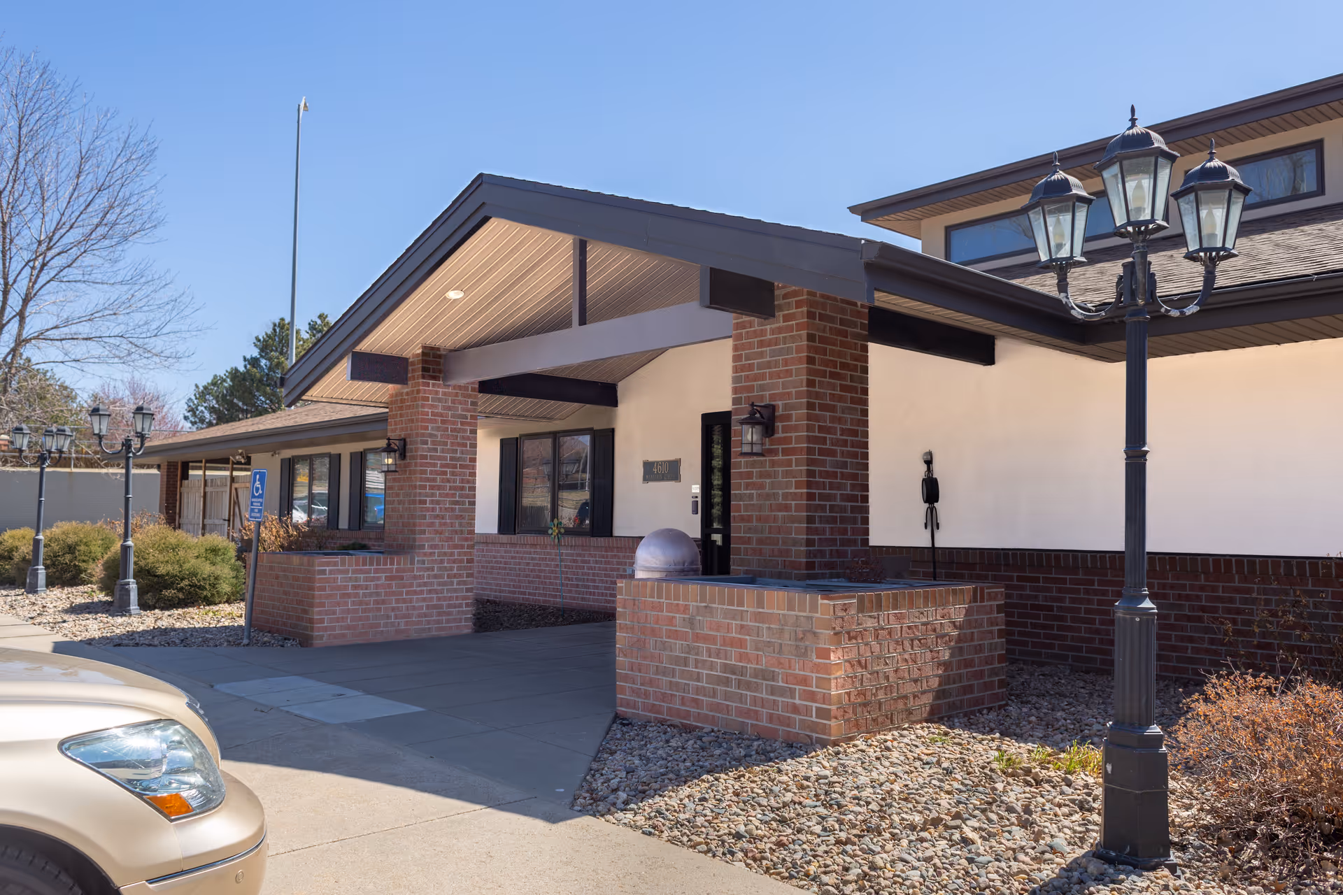 Exterior view of Independence Houses at Mandarin entrance with brick columns and lamps.