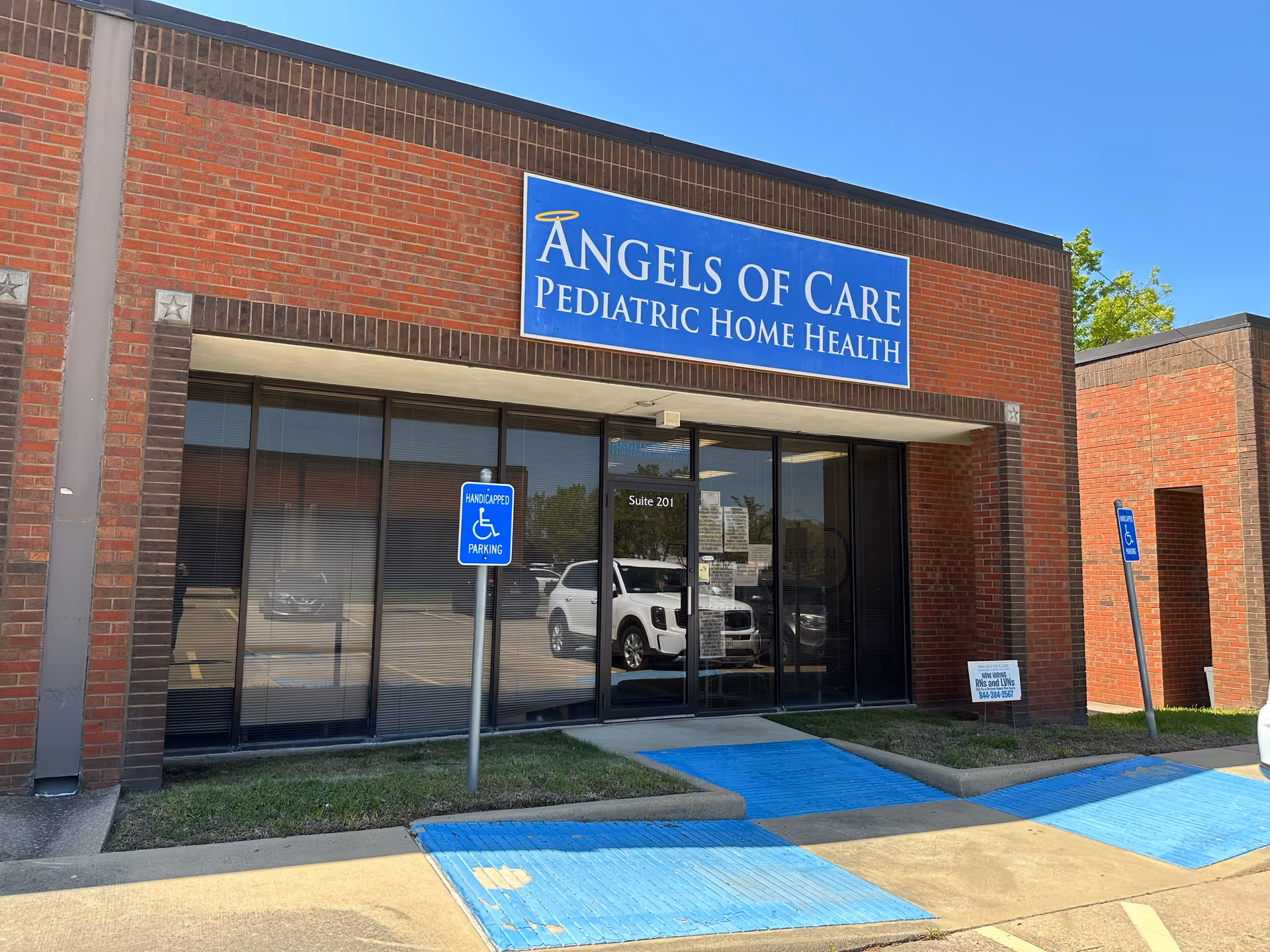 Brick building with Angels of Care Pediatric Home Health sign and glass entrance.