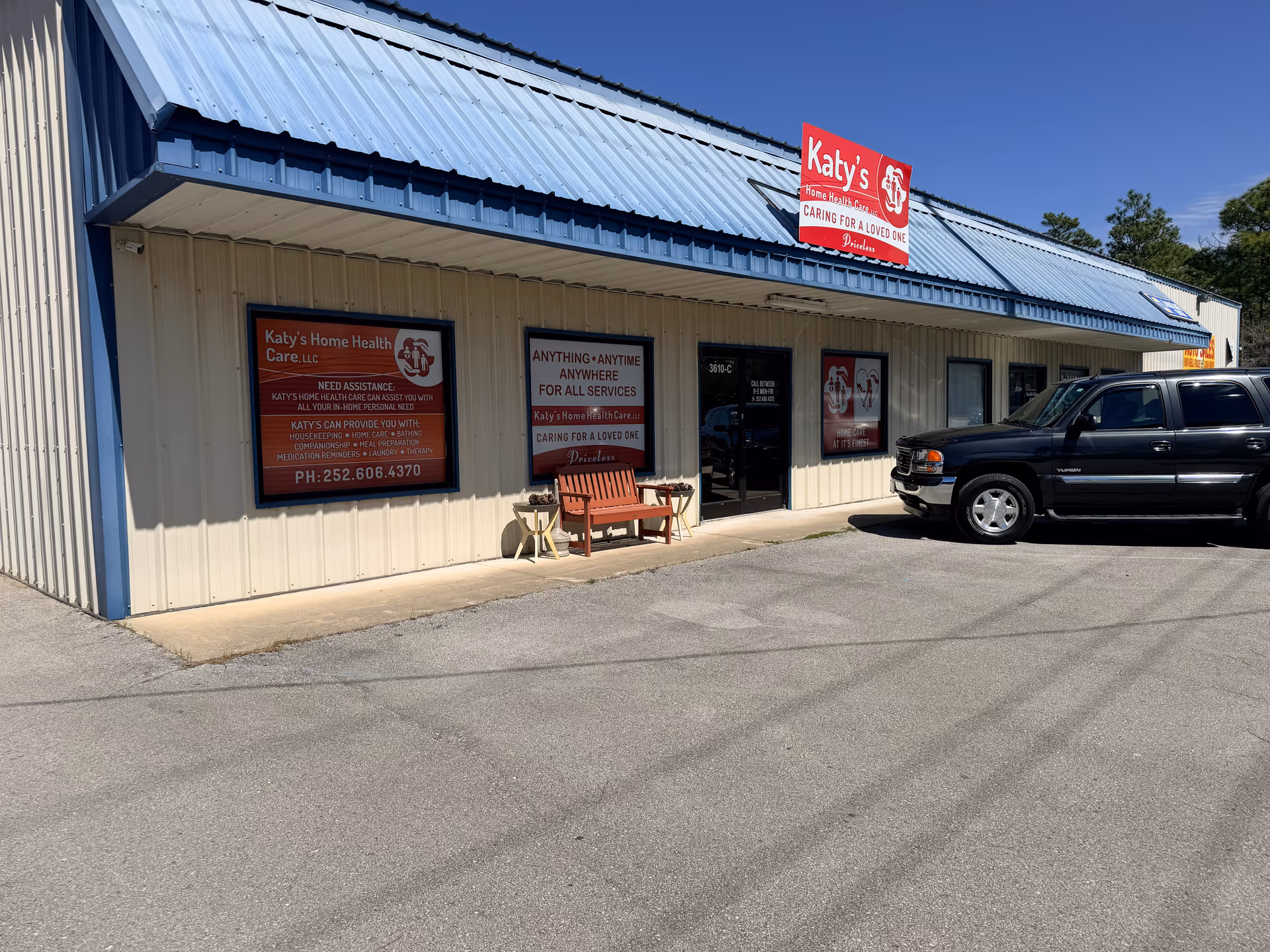 Exterior view of Katy's Home Health Care storefront with signs and a parked SUV.