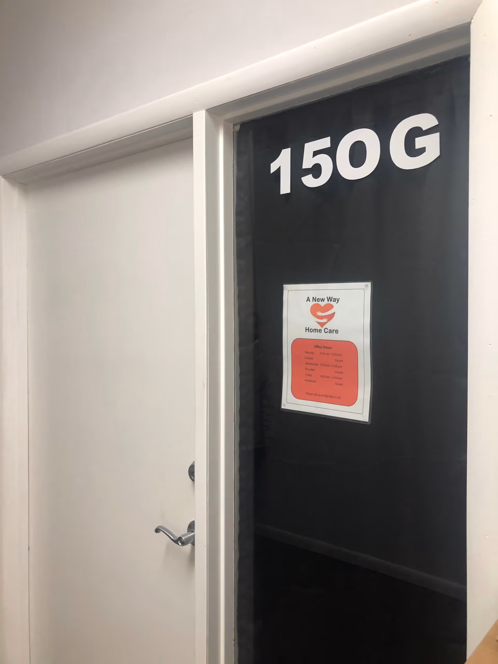 Interior hallway door labeled 150 G with a sign for A New Way Home Care