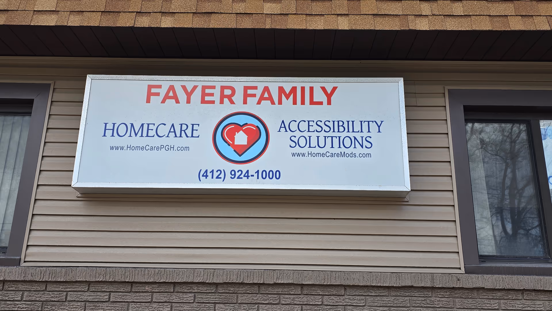 Exterior building with a large FAYER FAMILY sign advertising HomeCare and Accessibility Solutions.