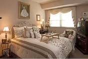 Cozy Clairmont Oaks bedroom featuring a bed, nightstands, seating, and a TV.