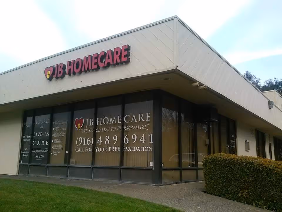 Exterior view of JB Homecare storefront with signage and large windowed front.
