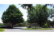 Exterior view of Lebanon Valley Home with circular driveway, green lawn, and trees.