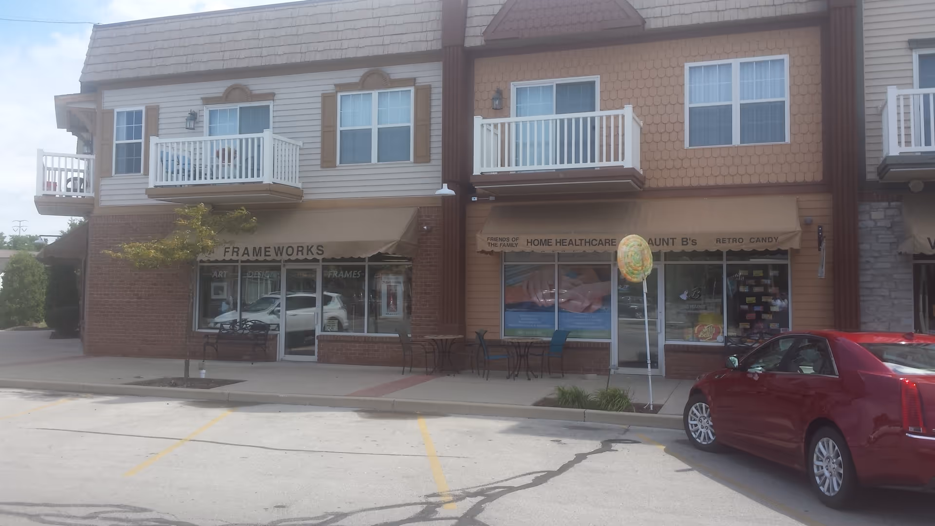 Street-view of a storefront strip with Friends of the Family Home Health Care signage.