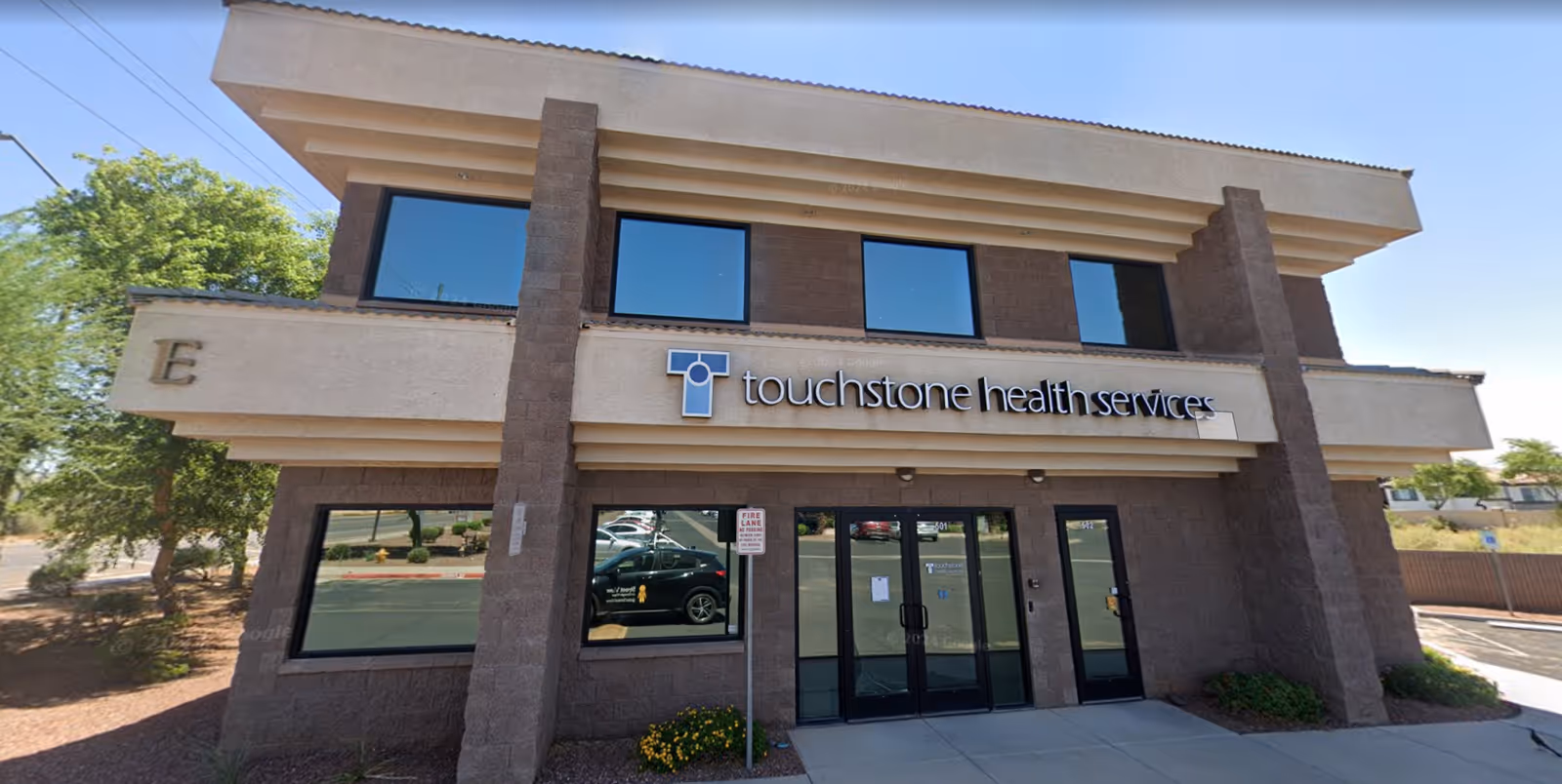 Exterior view of a two-story building with Touchstone Health Services sign.