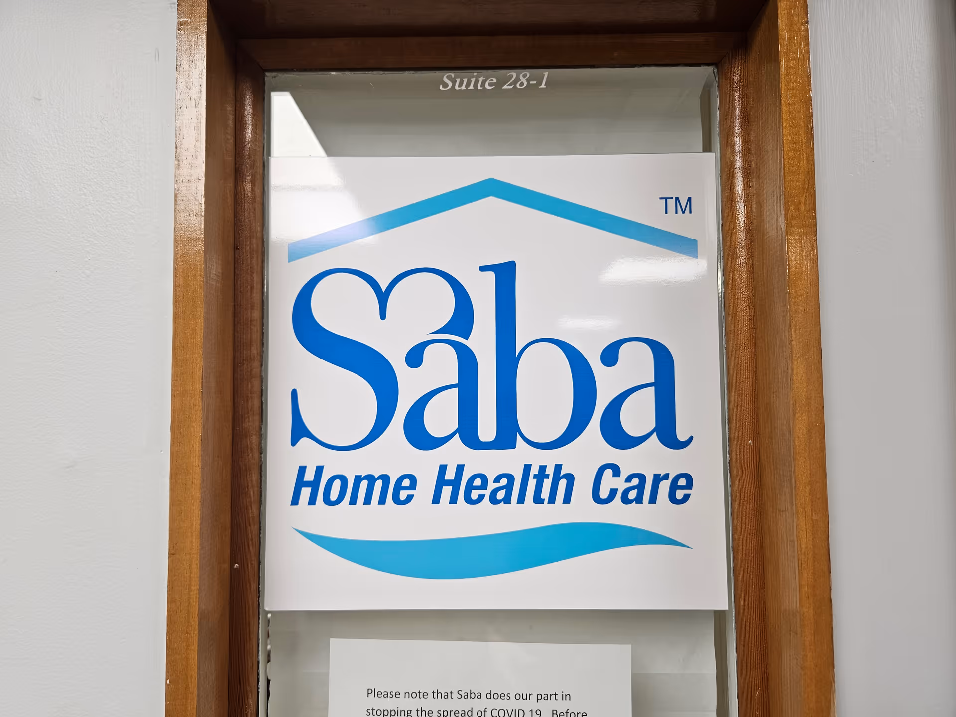 Entrance doorway with a large Saba Home Health Care sign, Suite 28-1.