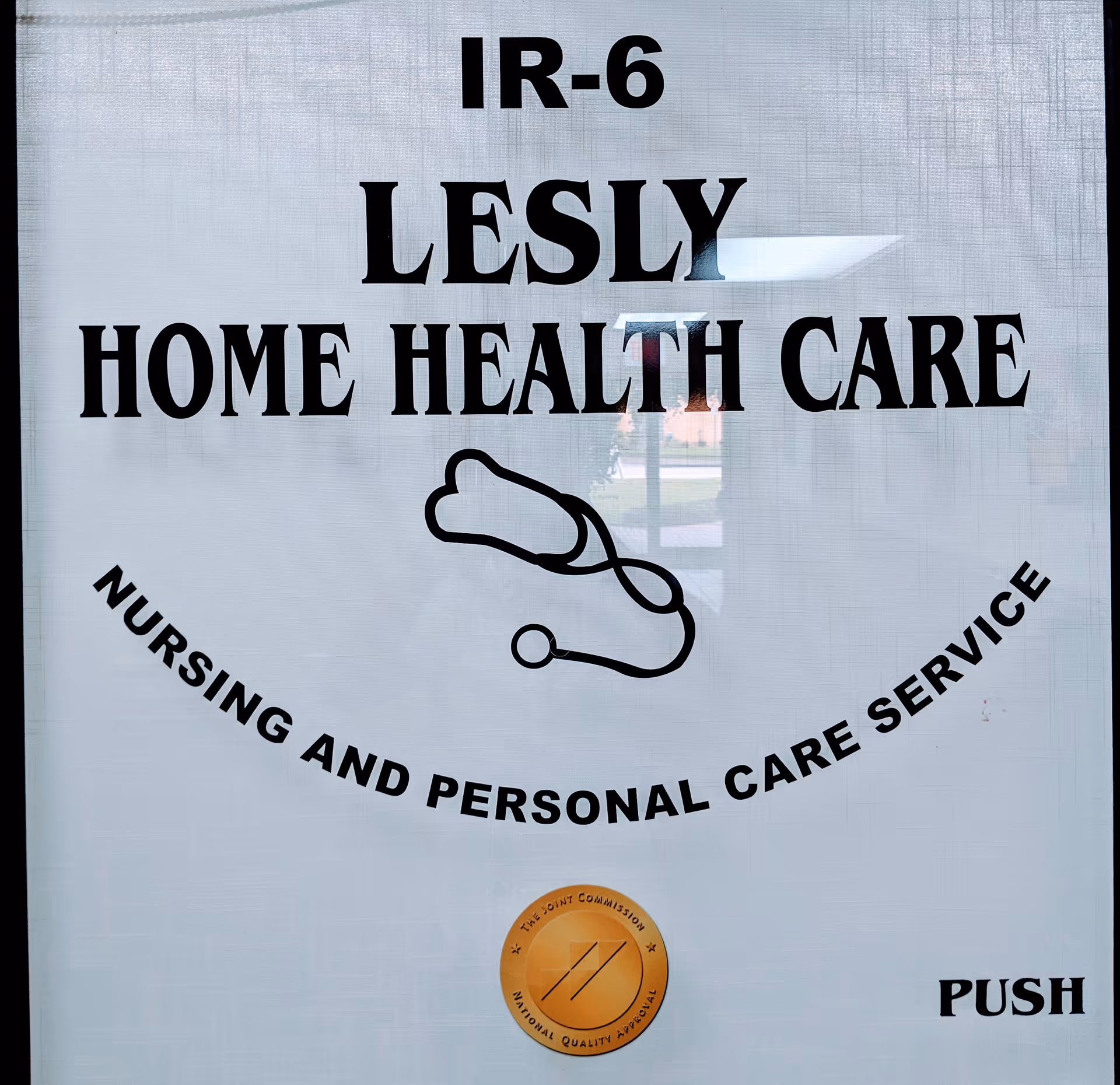 Front entrance sign for Lesly Home Health Care with stethoscope graphic and seal.