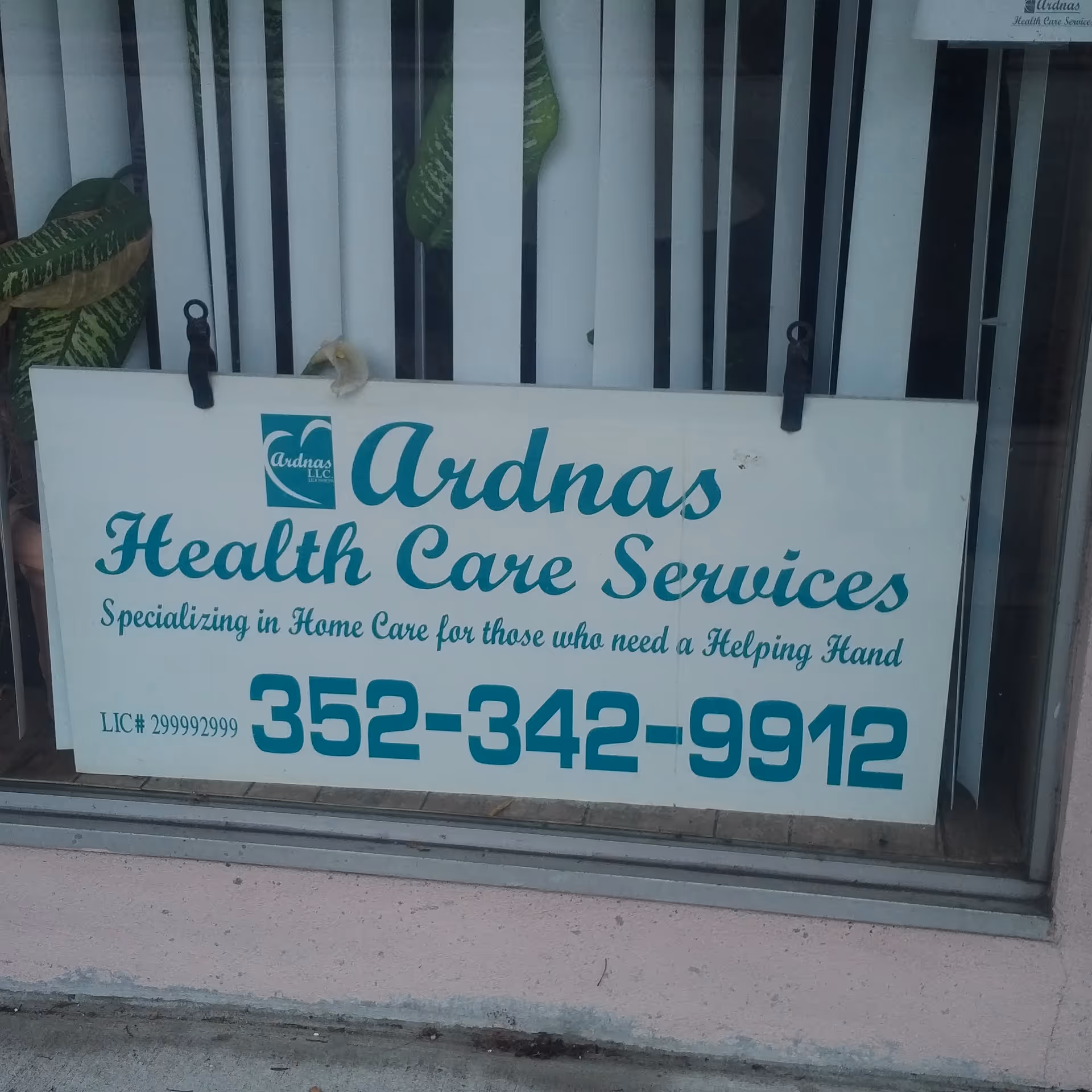Signboard for Ardnas Health Care Services displayed in a storefront window.