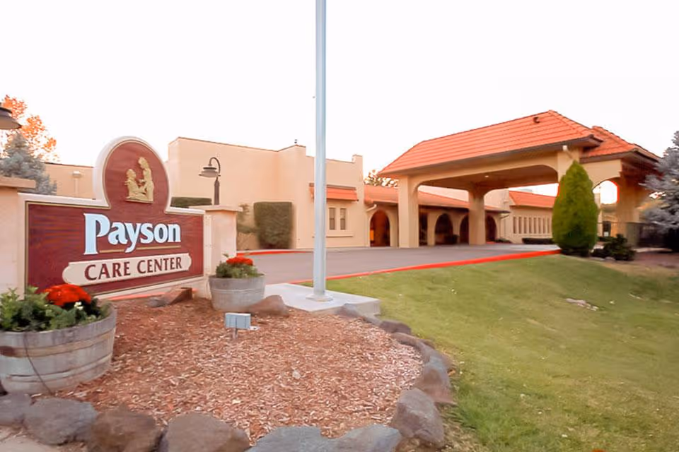 Front entrance of Payson Care Center with a large sign, covered porte-cochere, and landscaped grounds.