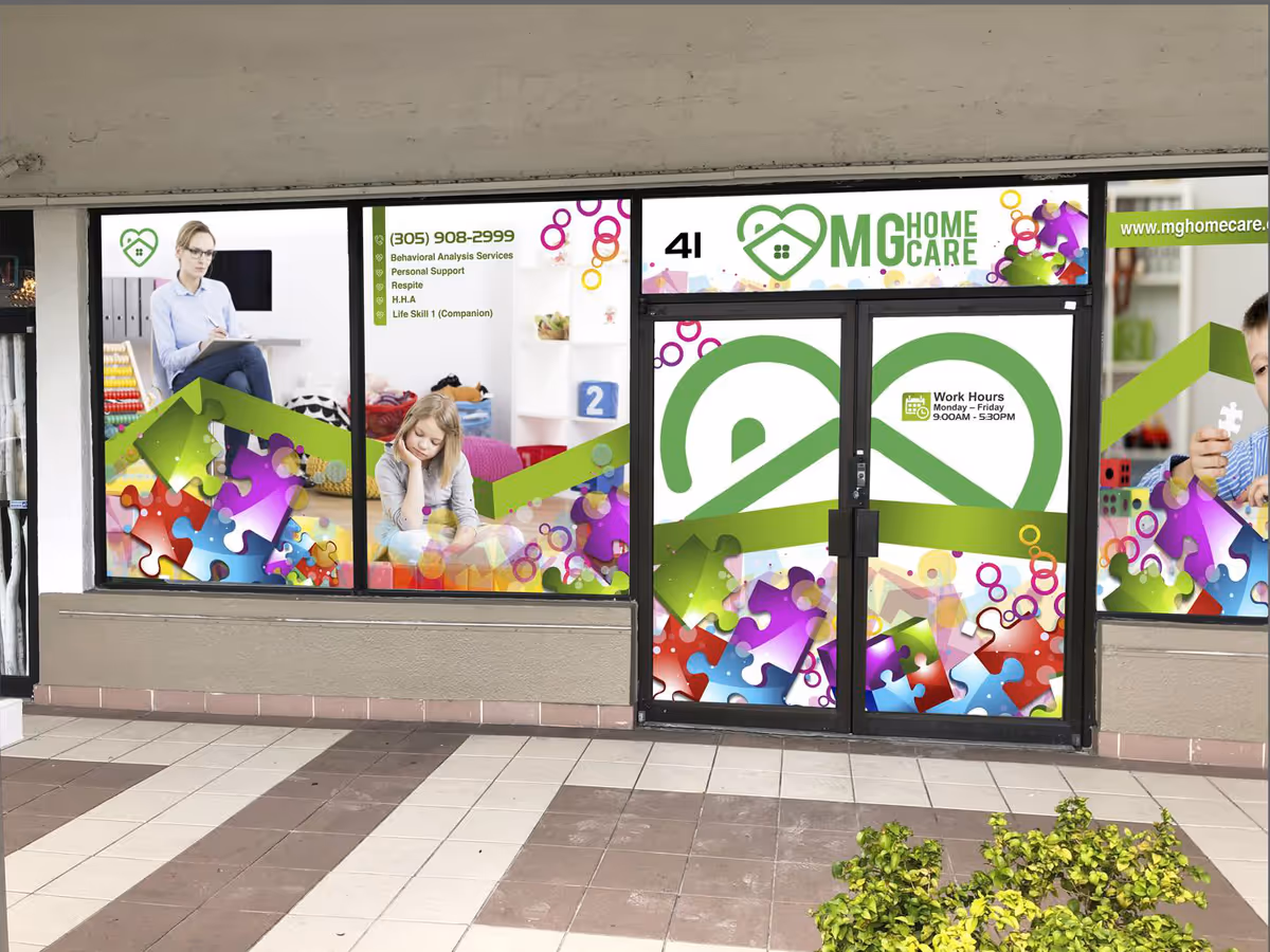 Exterior storefront window displays with colorful MG Home Care signage and abstract graphics.