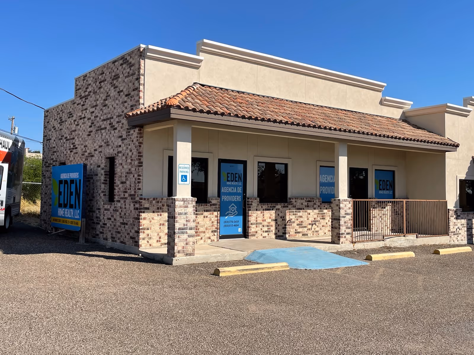 Front view of a single-story beige building with brick accents and Eden Home Health signage.