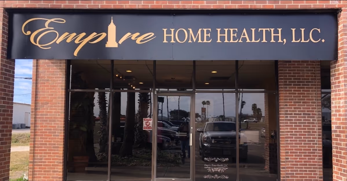Brick storefront with large sign reading Empire Home Health, LLC, glass entrance doors.