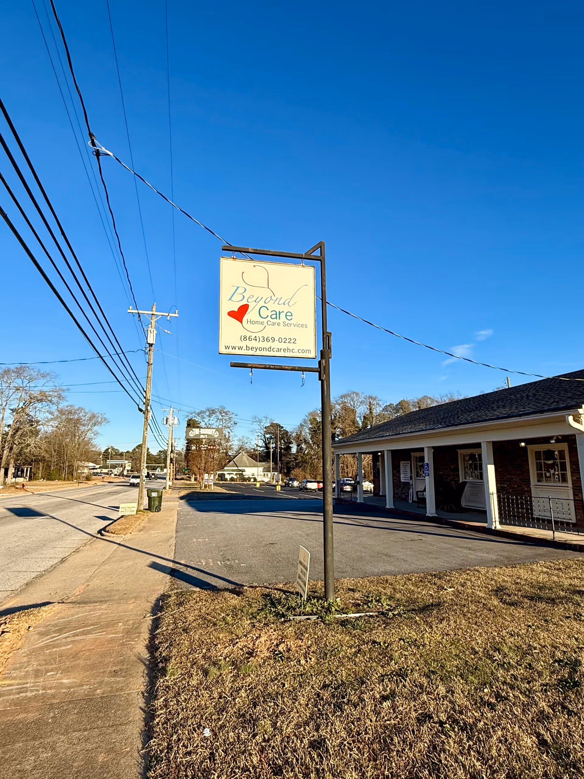 Exterior view of Beyond Care Home Care Services with sign along the street