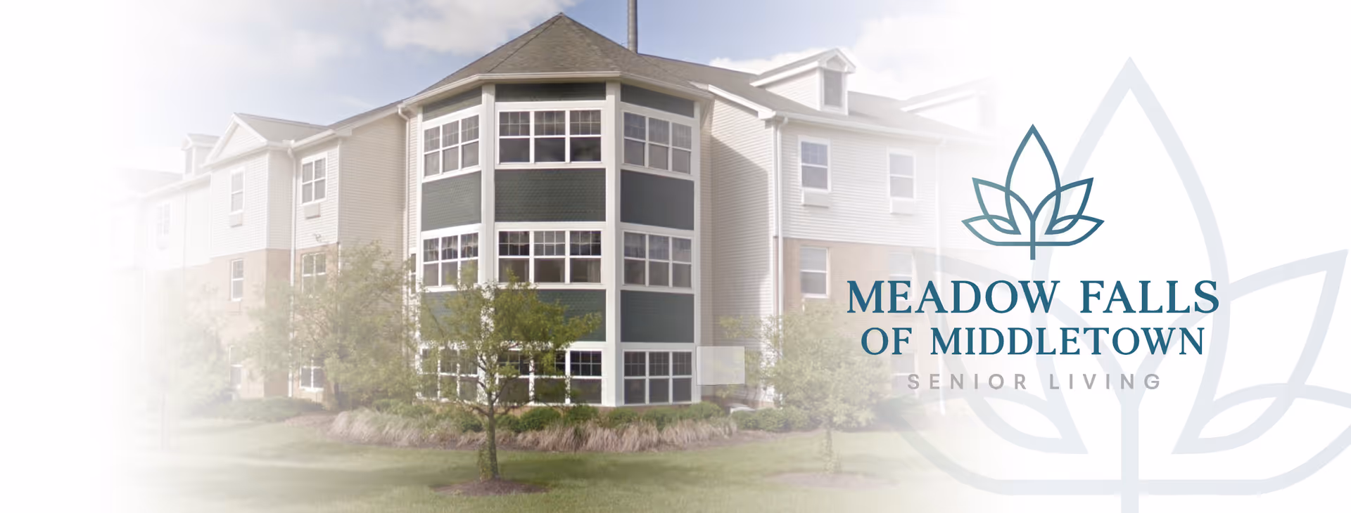 Exterior view of a multi-story senior living building with a manicured lawn.