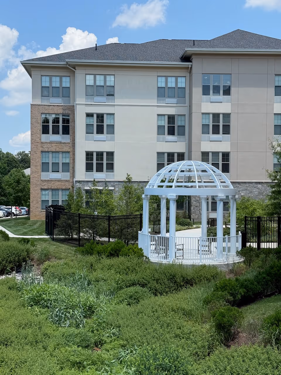 Charlestown Community senior living building with a white gazebo and landscaped courtyard.