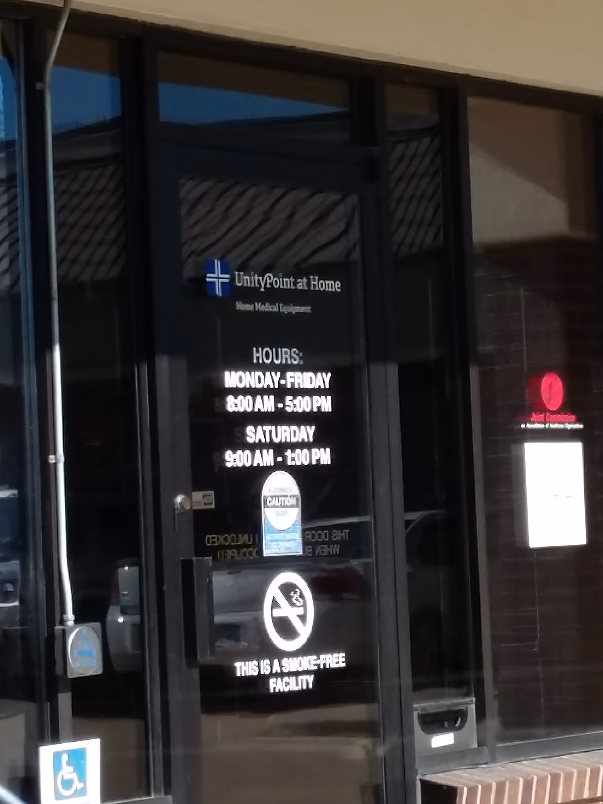 Glass entrance door with UnityPoint at Home signage and hours, no people visible.