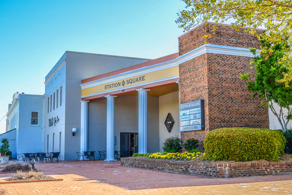 Exterior view of Station Square building with brick facade, columns, and outdoor seating.