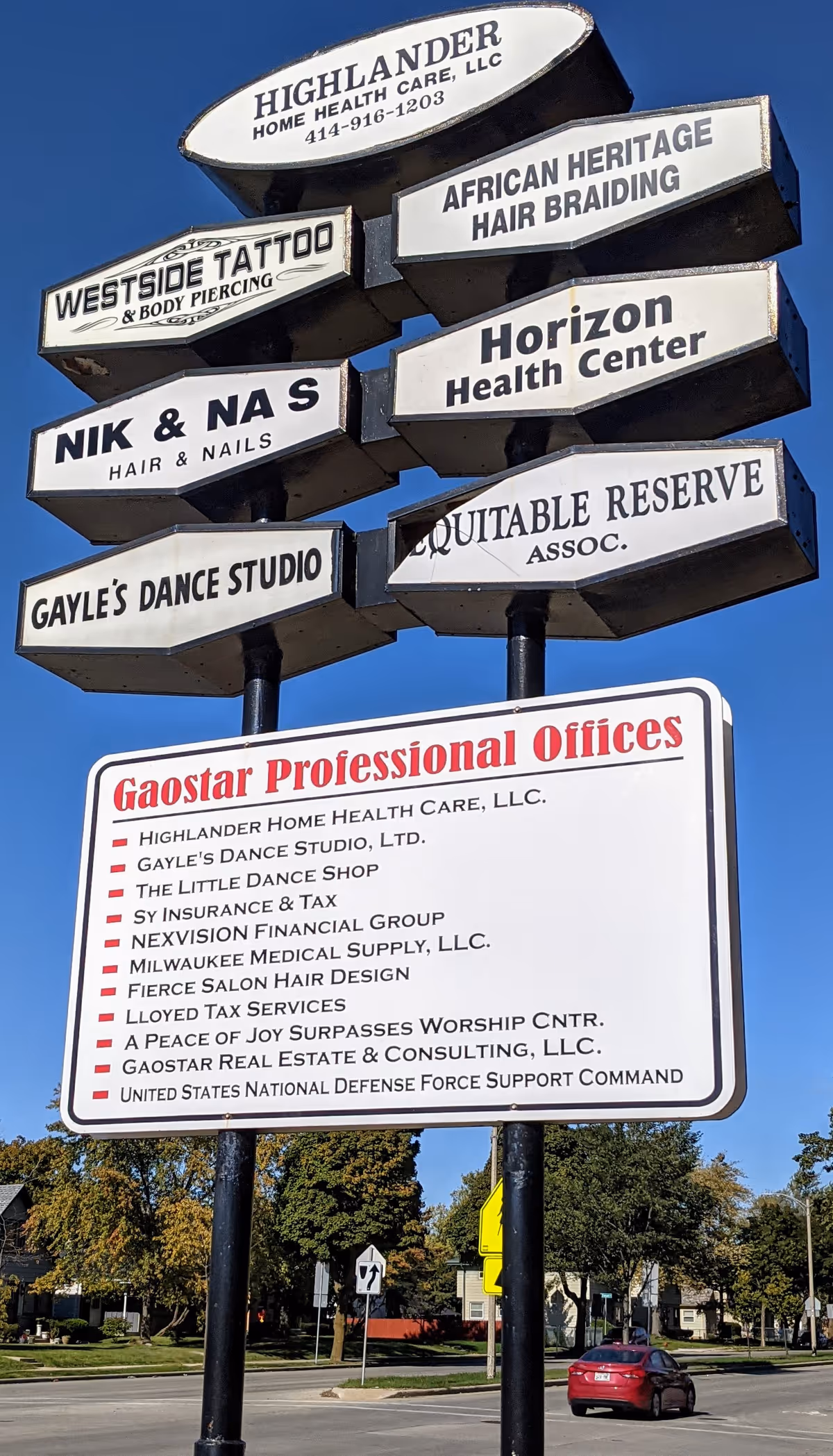 Outdoor signpost displaying multiple business signs, including Highlander Home Health Care.
