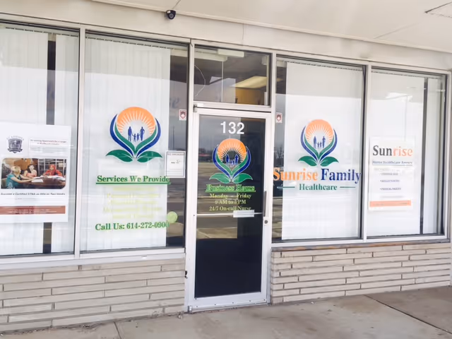 Exterior storefront of Sunrise Family Healthcare, with logoed windows and entrance.