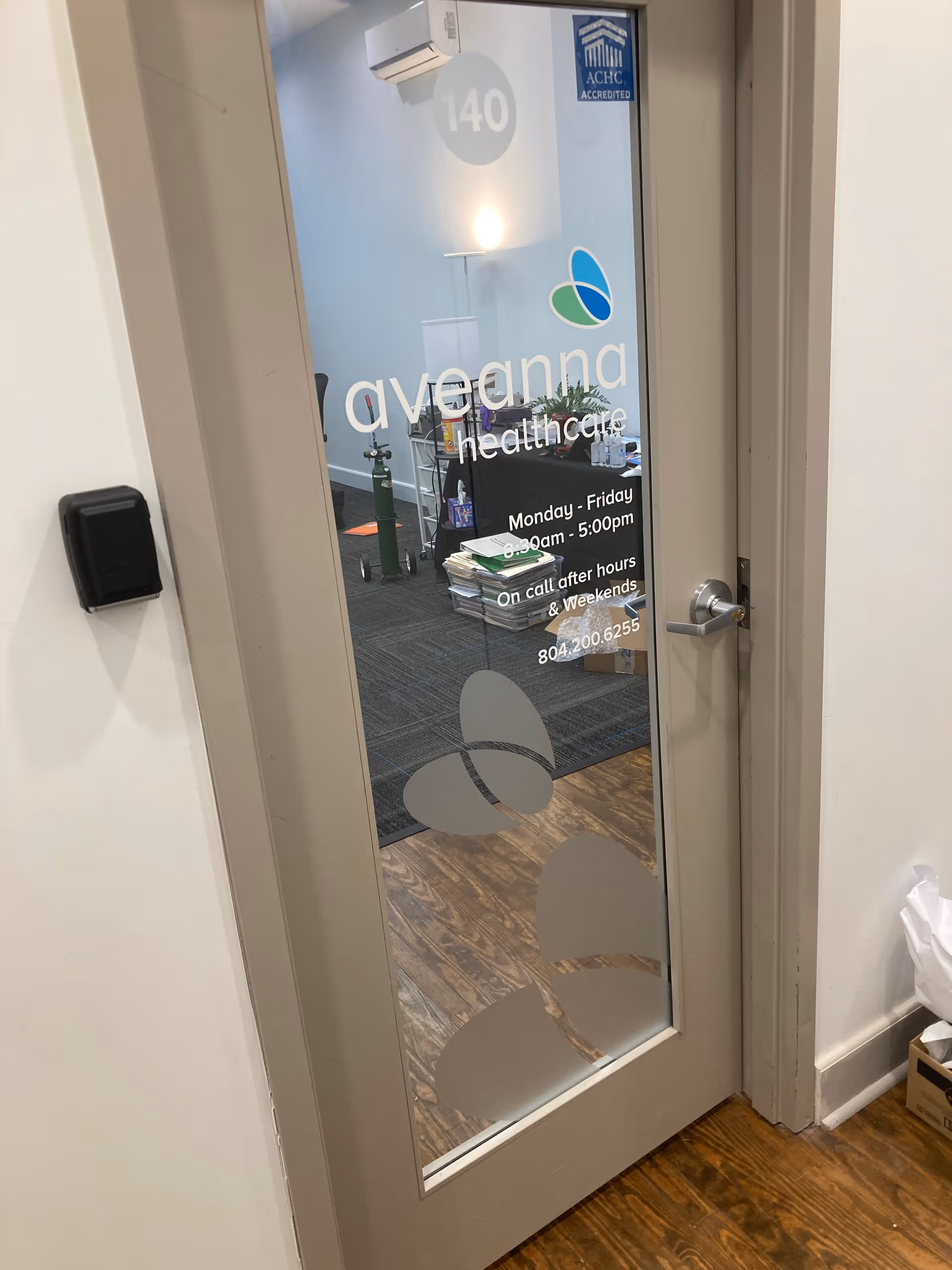 Glass door with Aveanna Healthcare branding reveals a reception area inside.