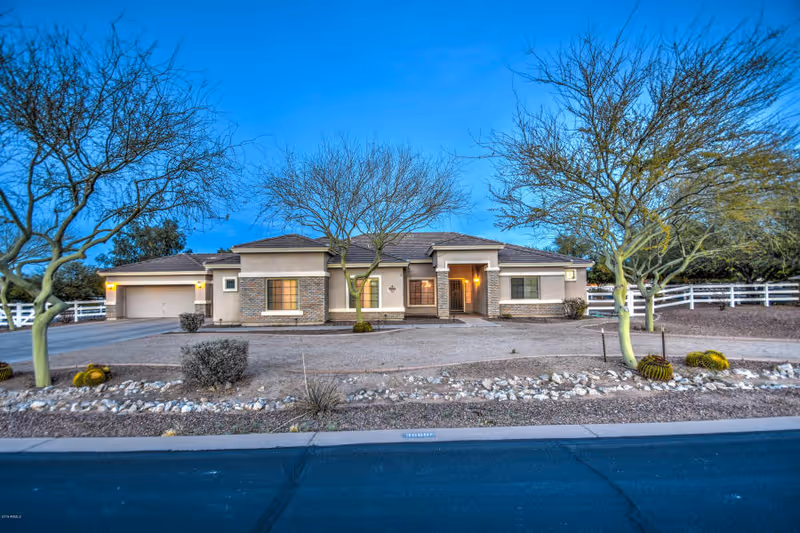 Front view of a single-story Arizona Sunset Assisted Living building with a curved driveway.
