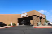 Exterior view of Coronado Healthcare Center with a covered entrance and brick accents.