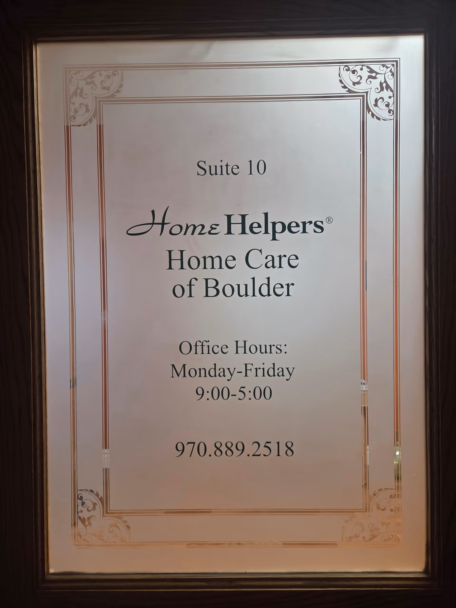 Framed interior sign: Suite 10, Home Helpers Home Care of Boulder, hours, and phone.