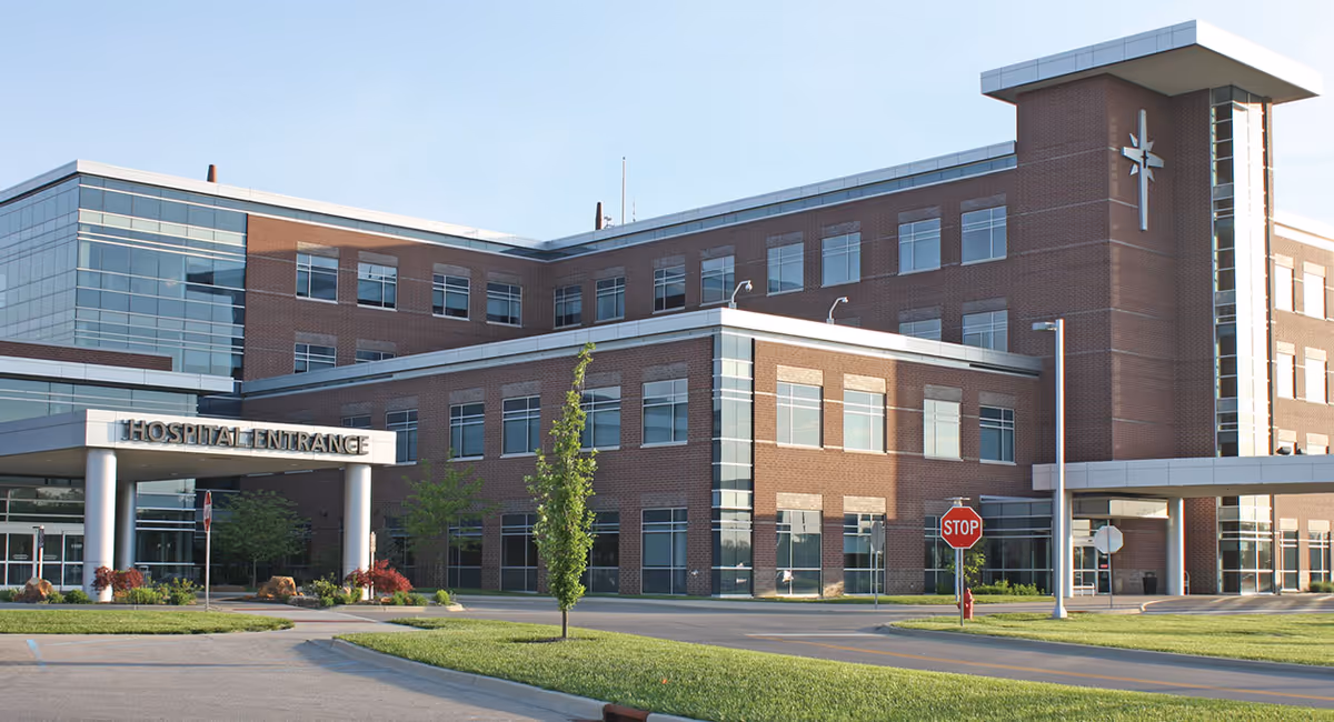 Brick medical building exterior with glass entrance and hospital signage.