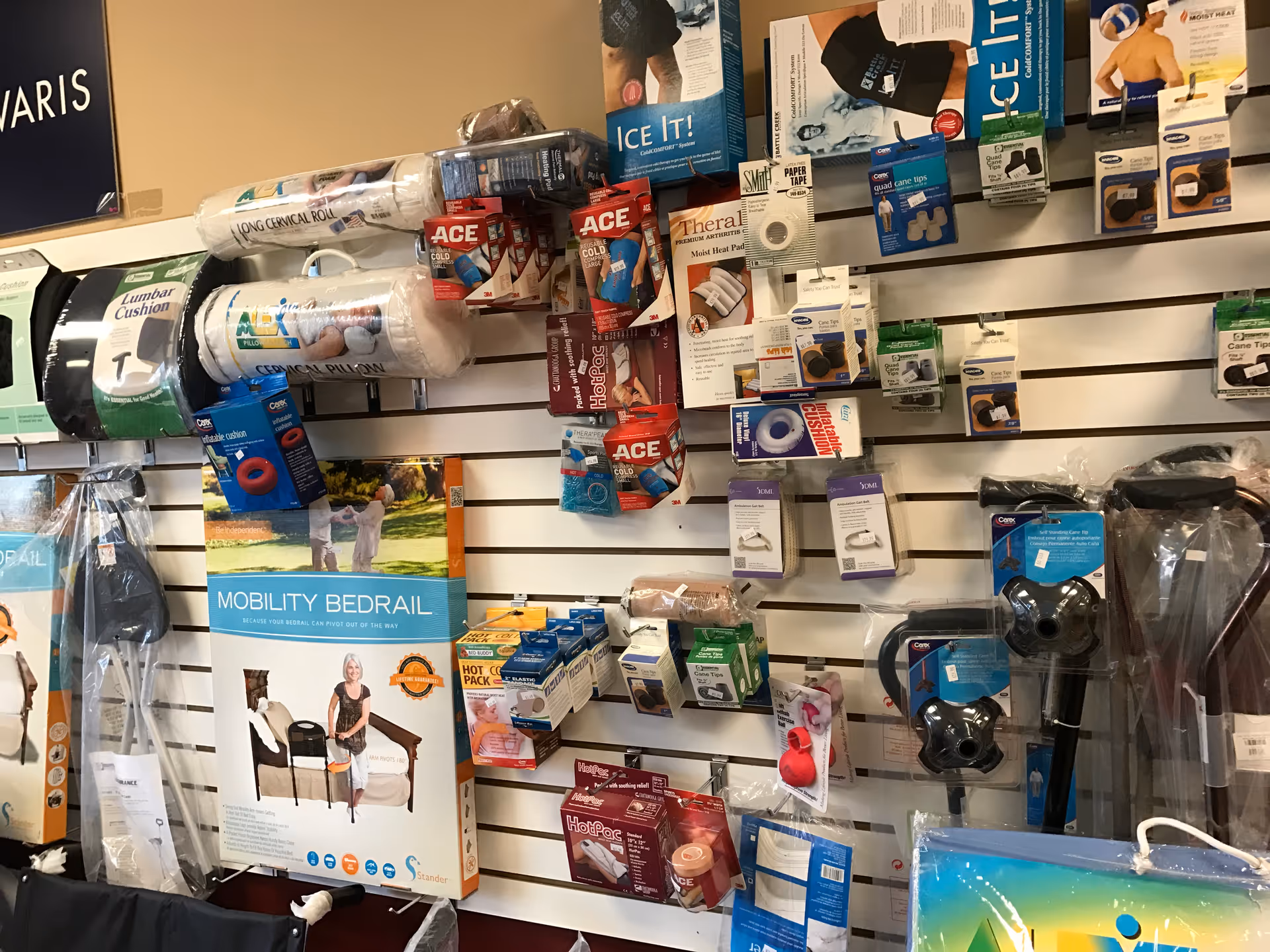 Wall of medical supplies and packaging mounted on a pegboard display.