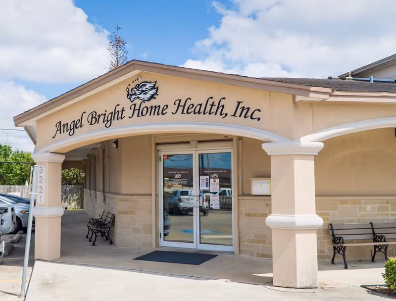 Exterior view of Angel Bright Home Health, Inc. entrance with benches and glass doors.