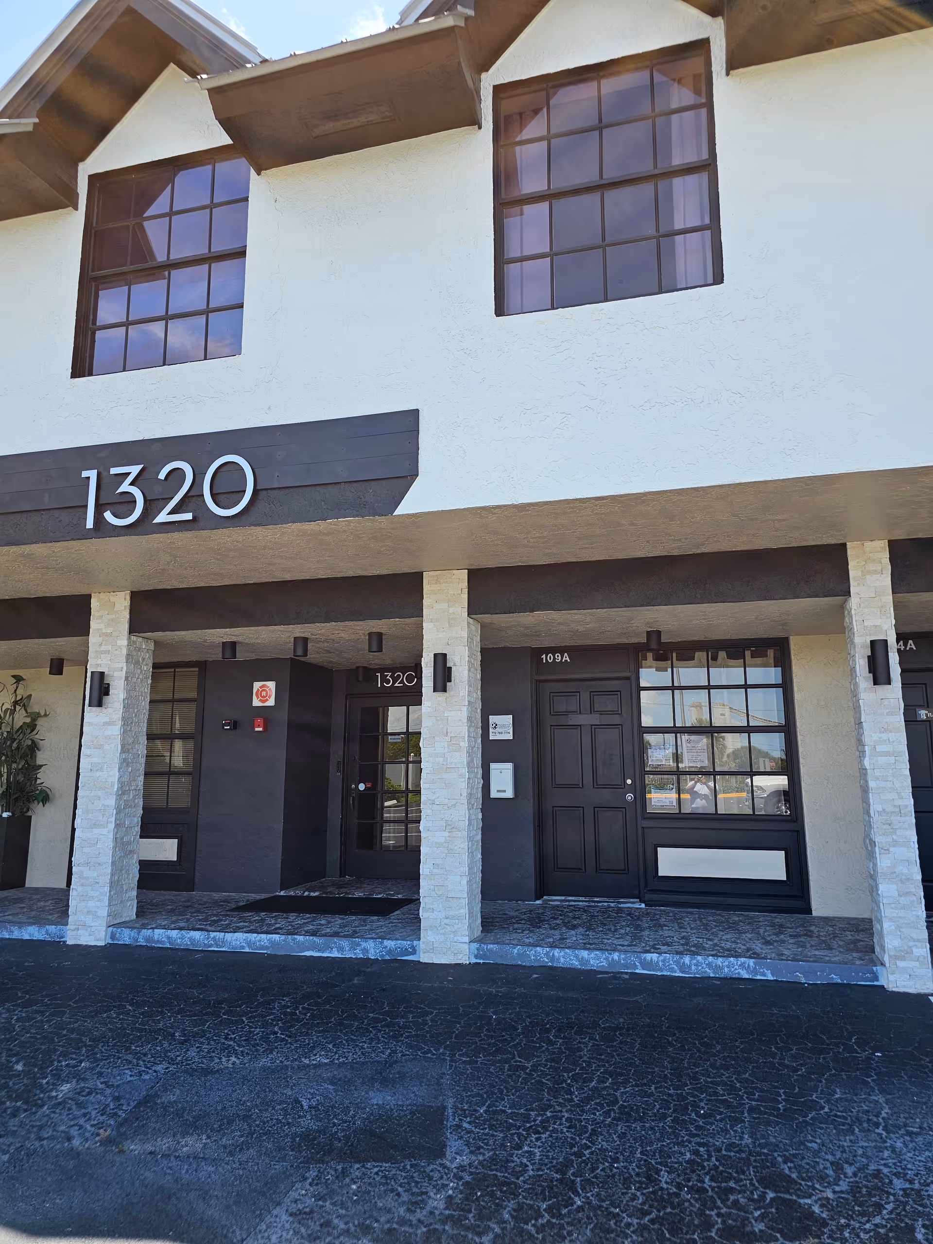 Exterior front of a senior living building with the address 1320
