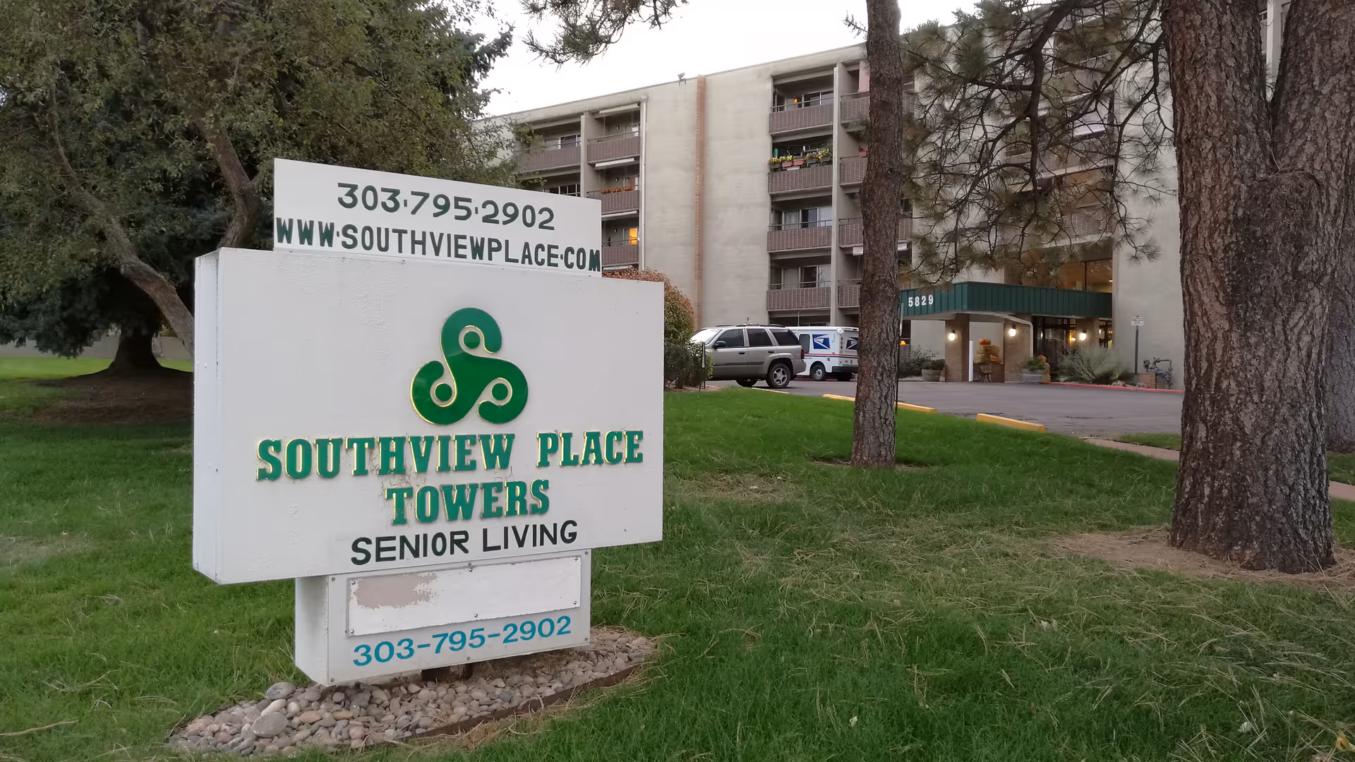 Exterior view of Southview Place Towers senior living with sign and building entrance.