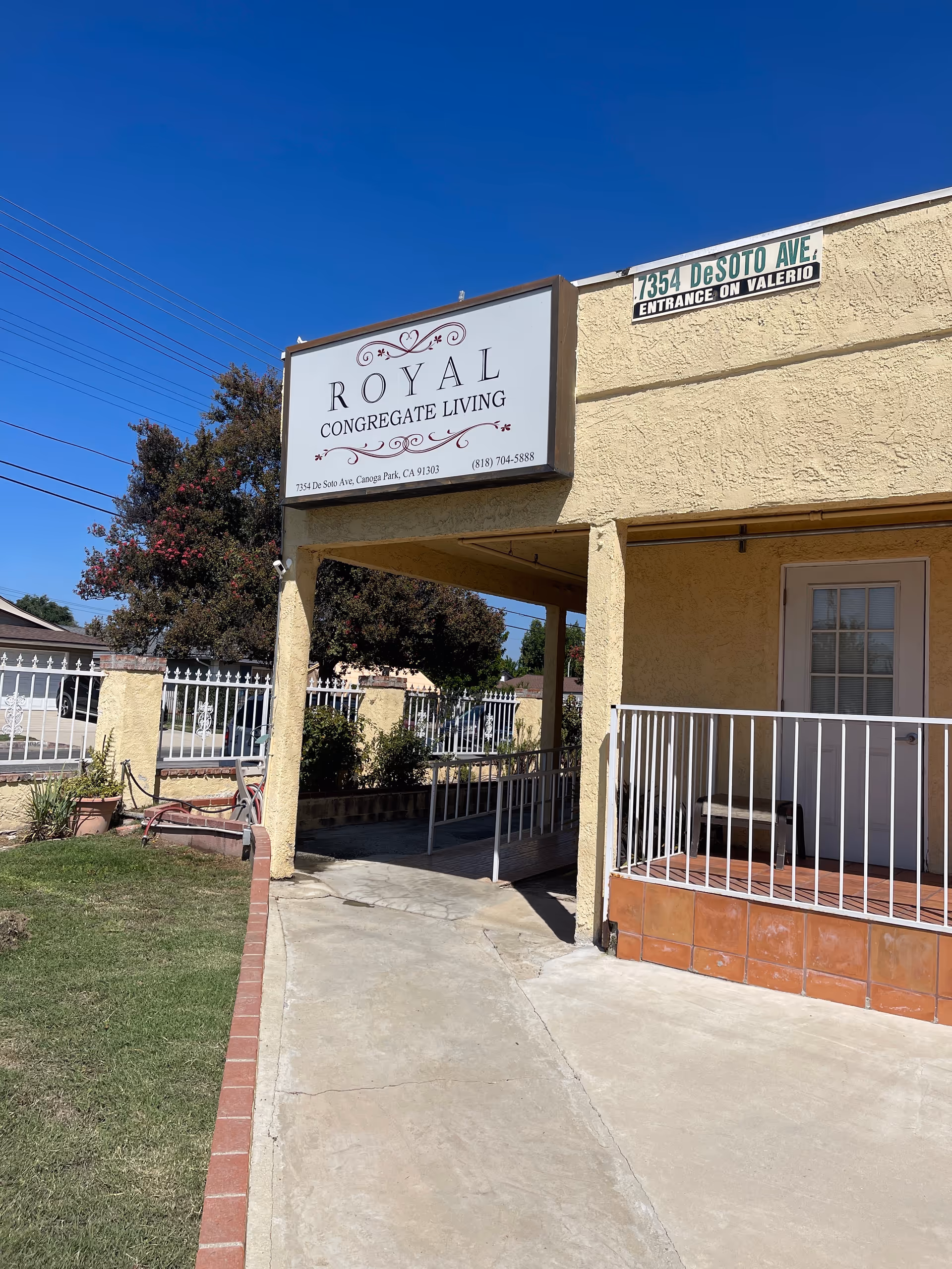 Front view of a beige senior living facility with a large Royal Congregate Living sign.