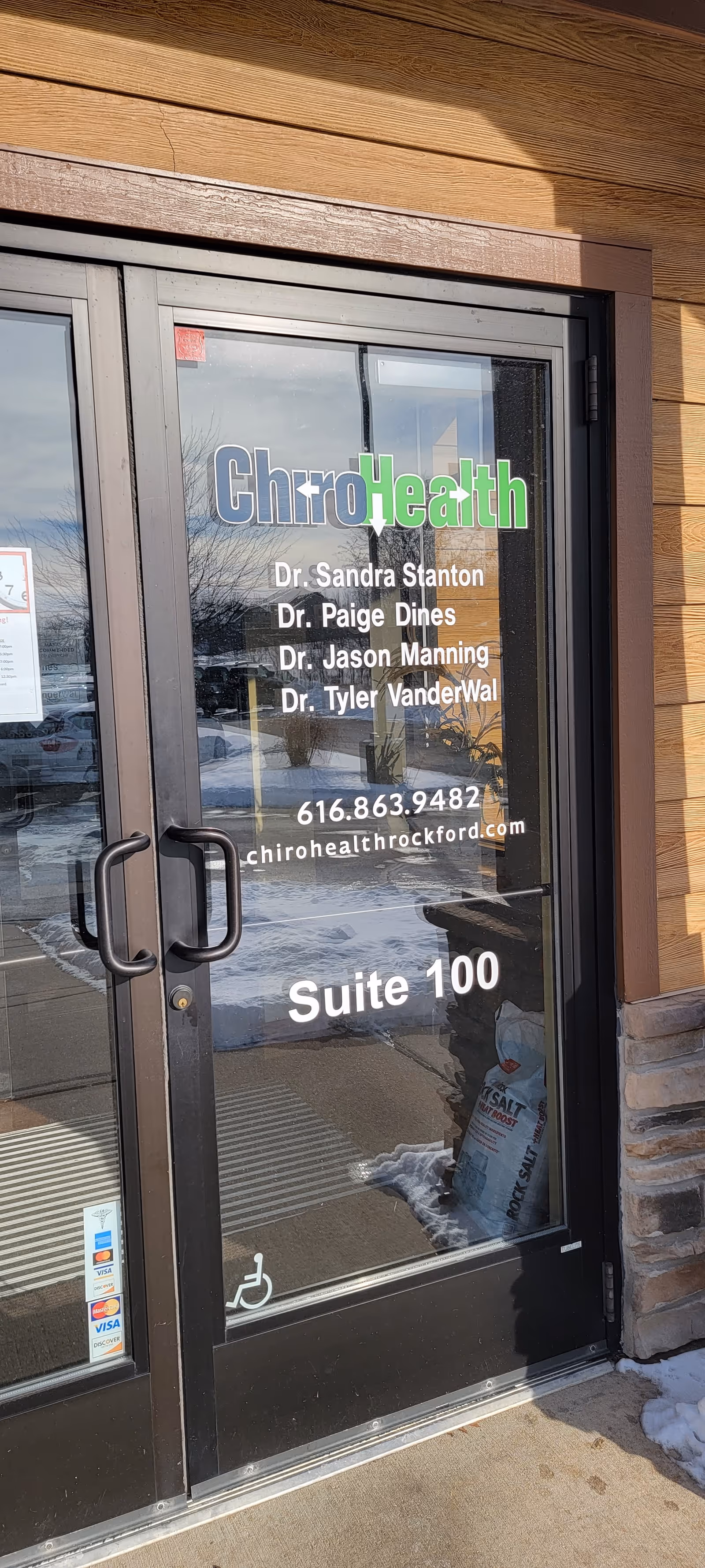 Glass entrance door displaying ChiroHealth logo, doctors' names, and Suite 100 in Rockford.